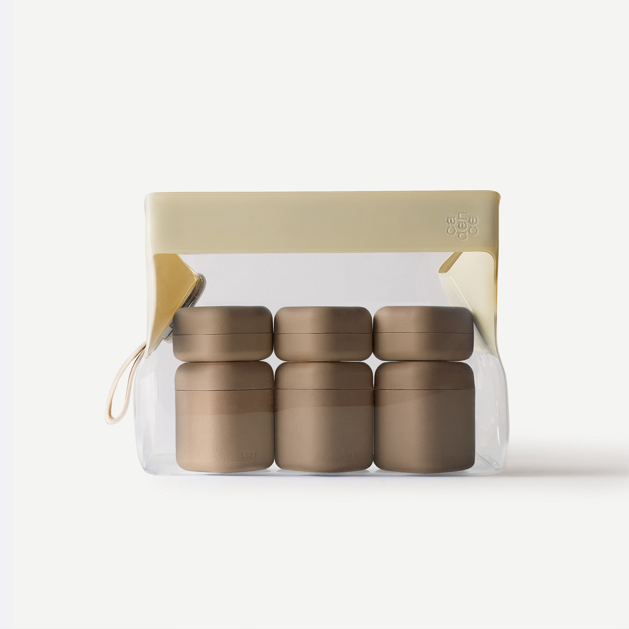 Set of four black containers in a clear plastic pack with beige lid on a white background