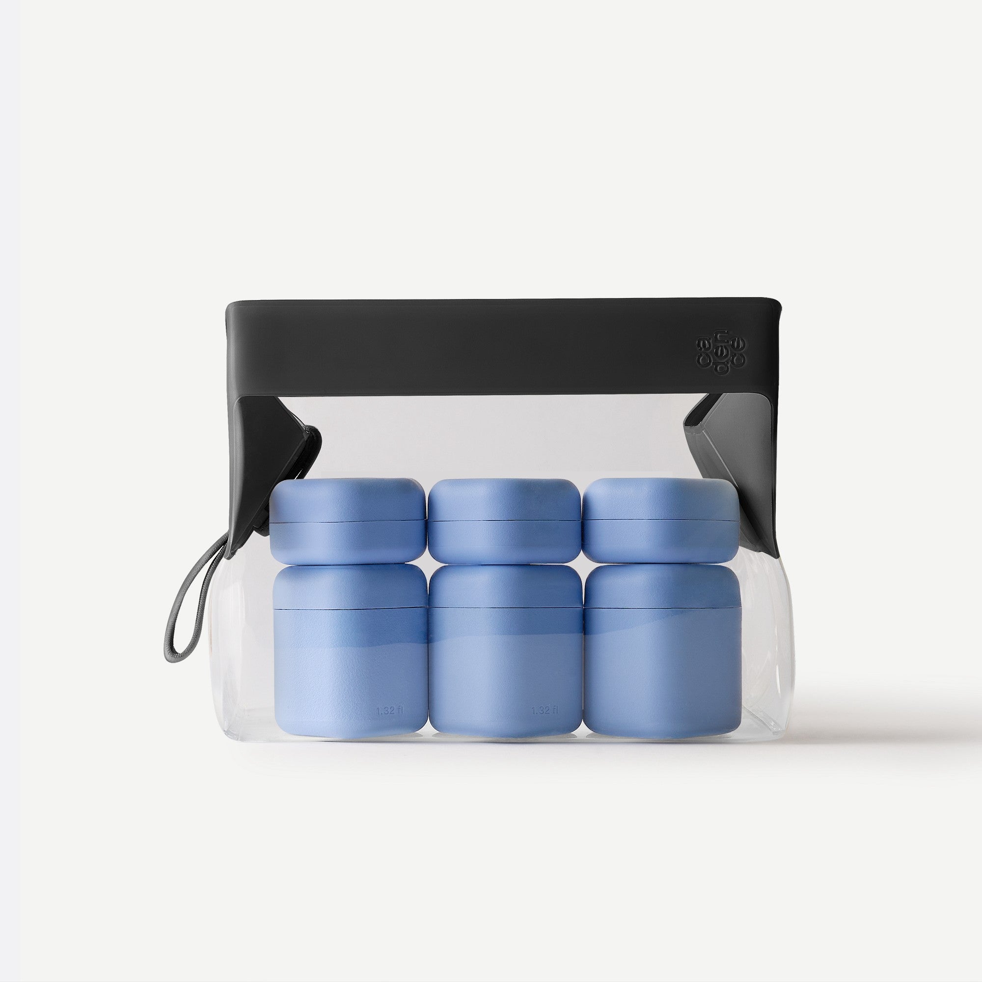Set of blue containers in a clear plastic bag with a black carrying handle on a white background