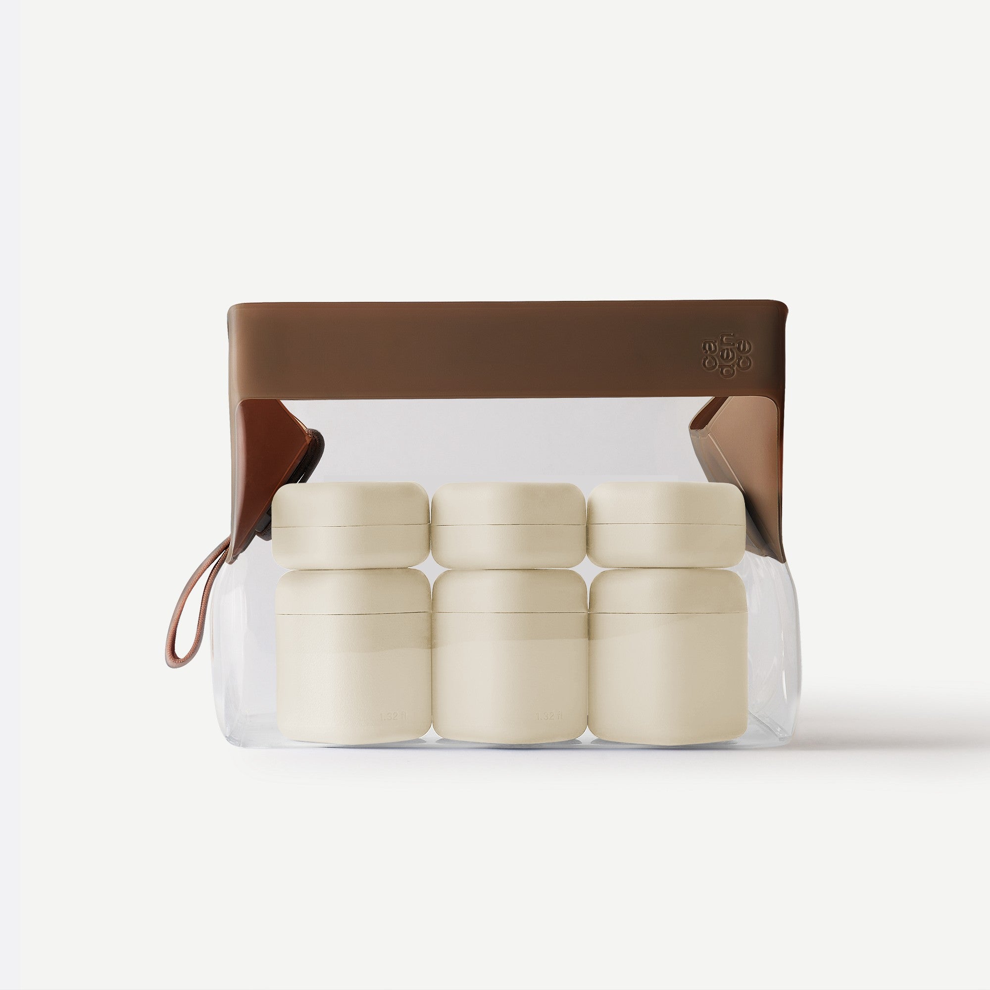 Set of five beige containers in a clear plastic pack with a brown leather strap on a white background