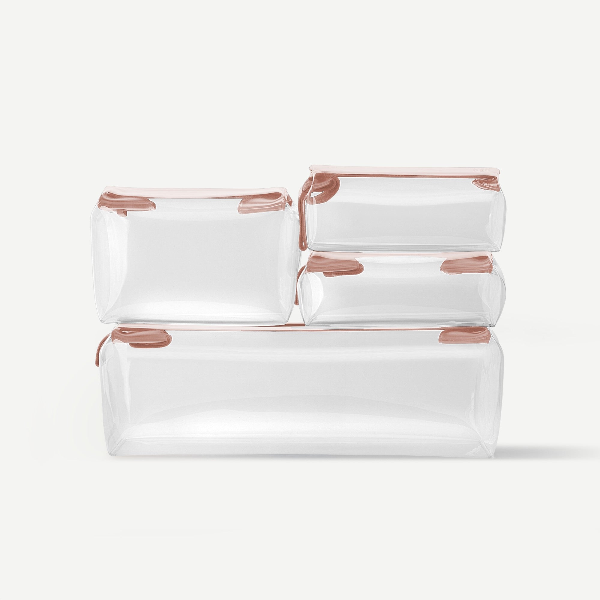 Set of white travel bags with rose gold zippers on a light gray background