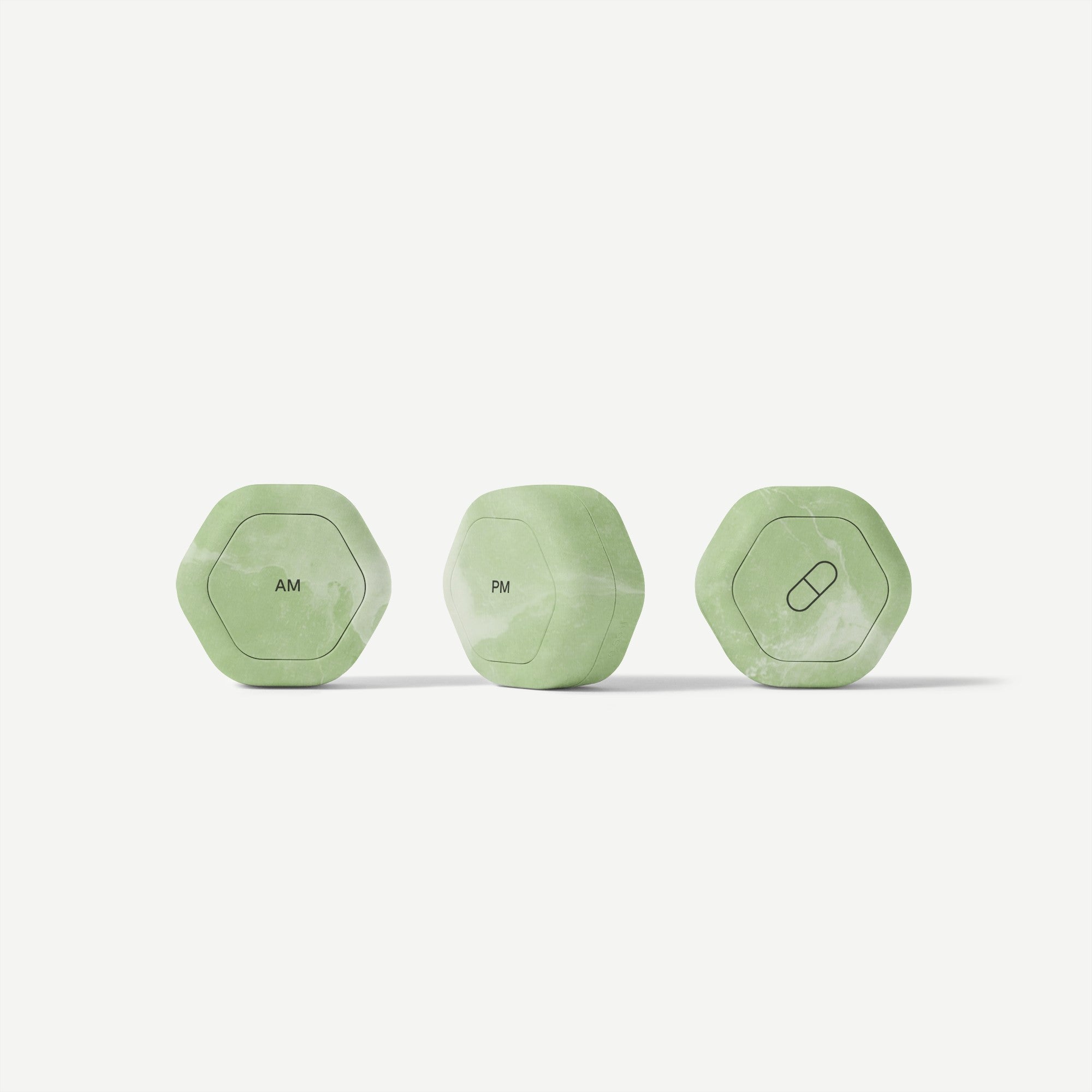 Three green hexagonal containers labeled 'AM', 'PM', and a pill icon on a white background