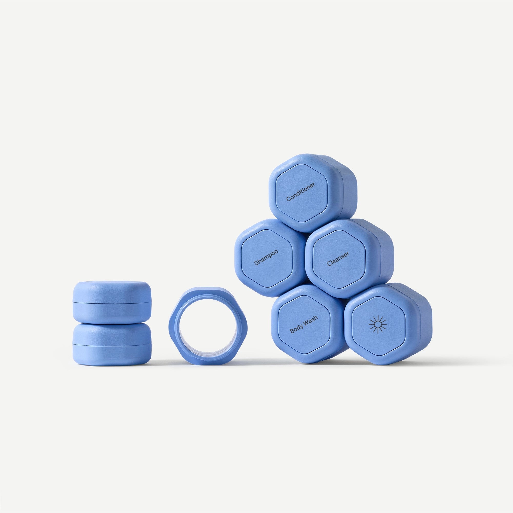 Set of blue hexagonal containers with labels on a white background