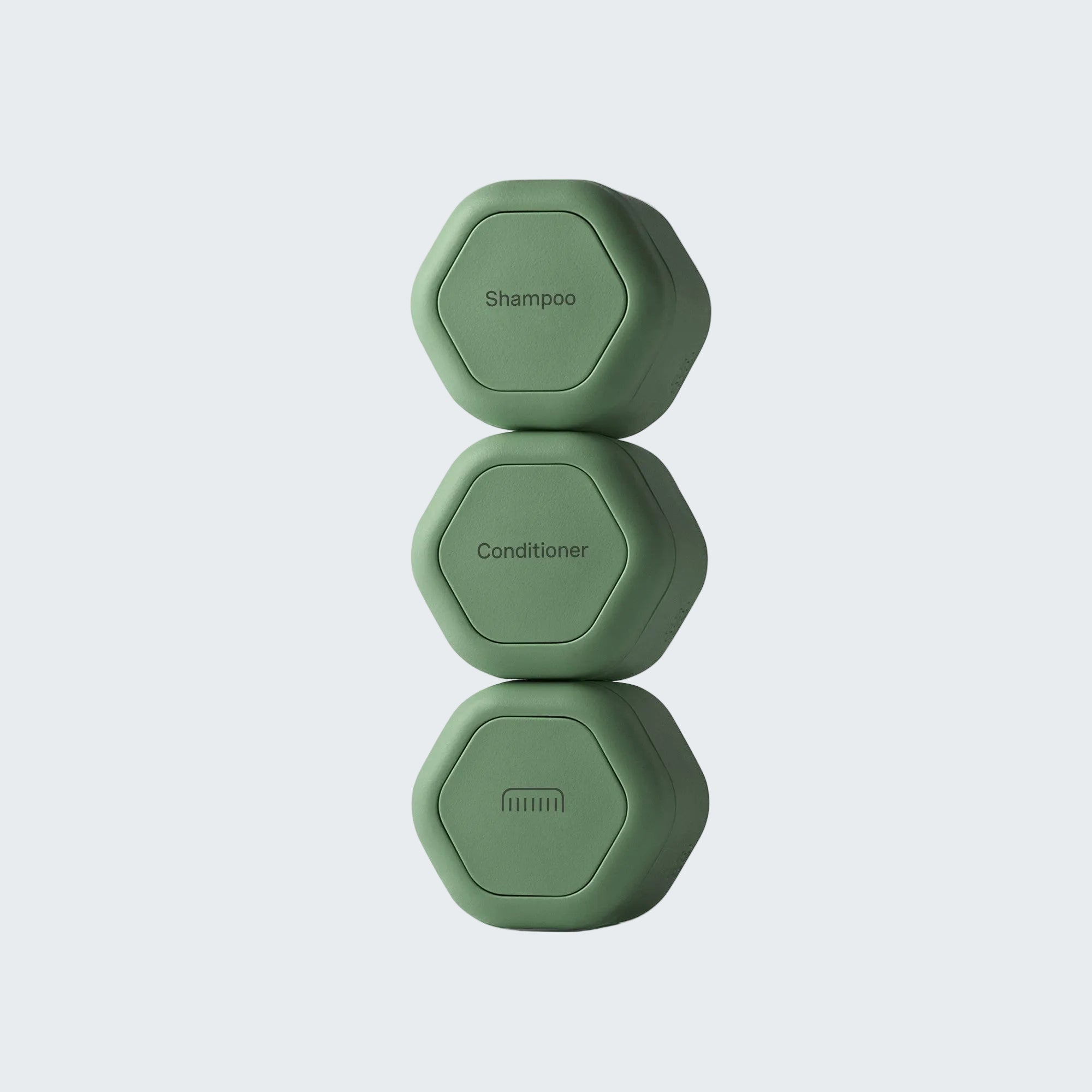 Three stacked hexagonal green shampoo and conditioner dispensers on a light gray background.