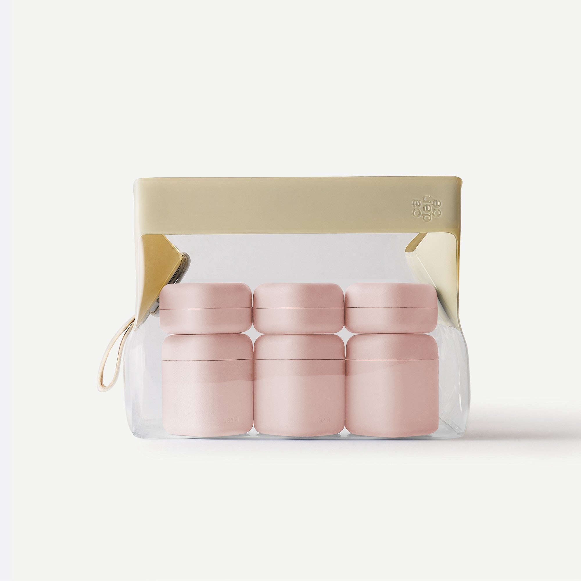 Set of pink containers in a clear packaging with a gold accent on a white background