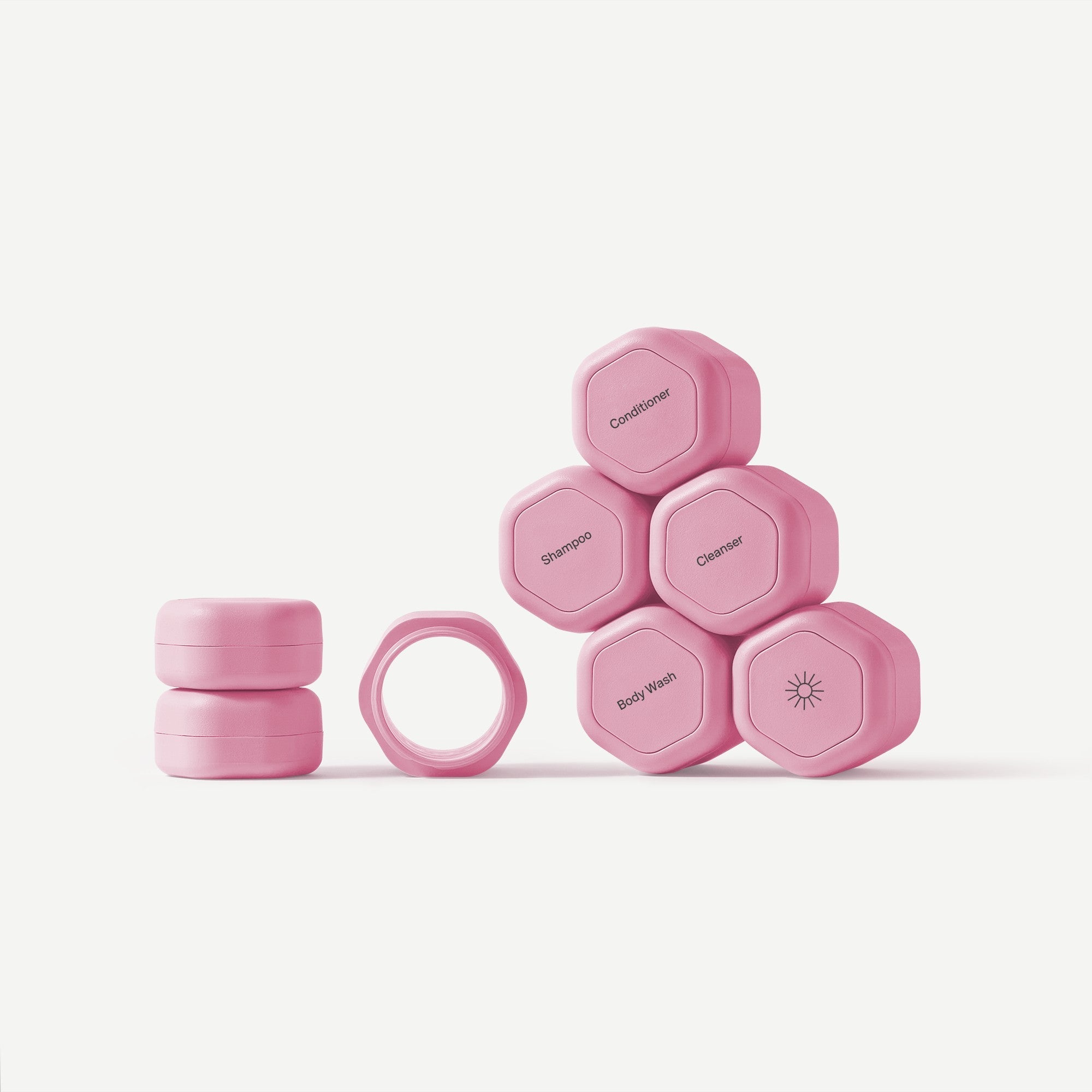 Set of pink plastic containers with labels on a white background