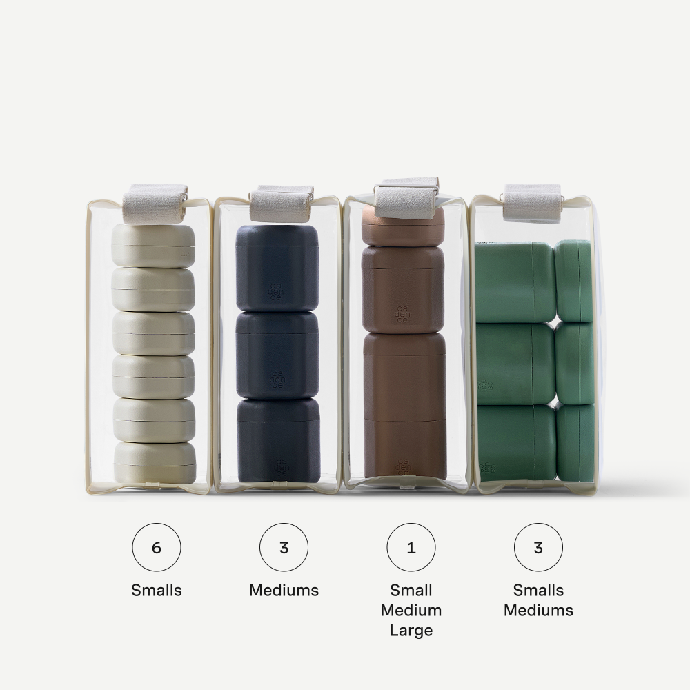 Set of containers with different sizes filled with cylindrical items on a white background