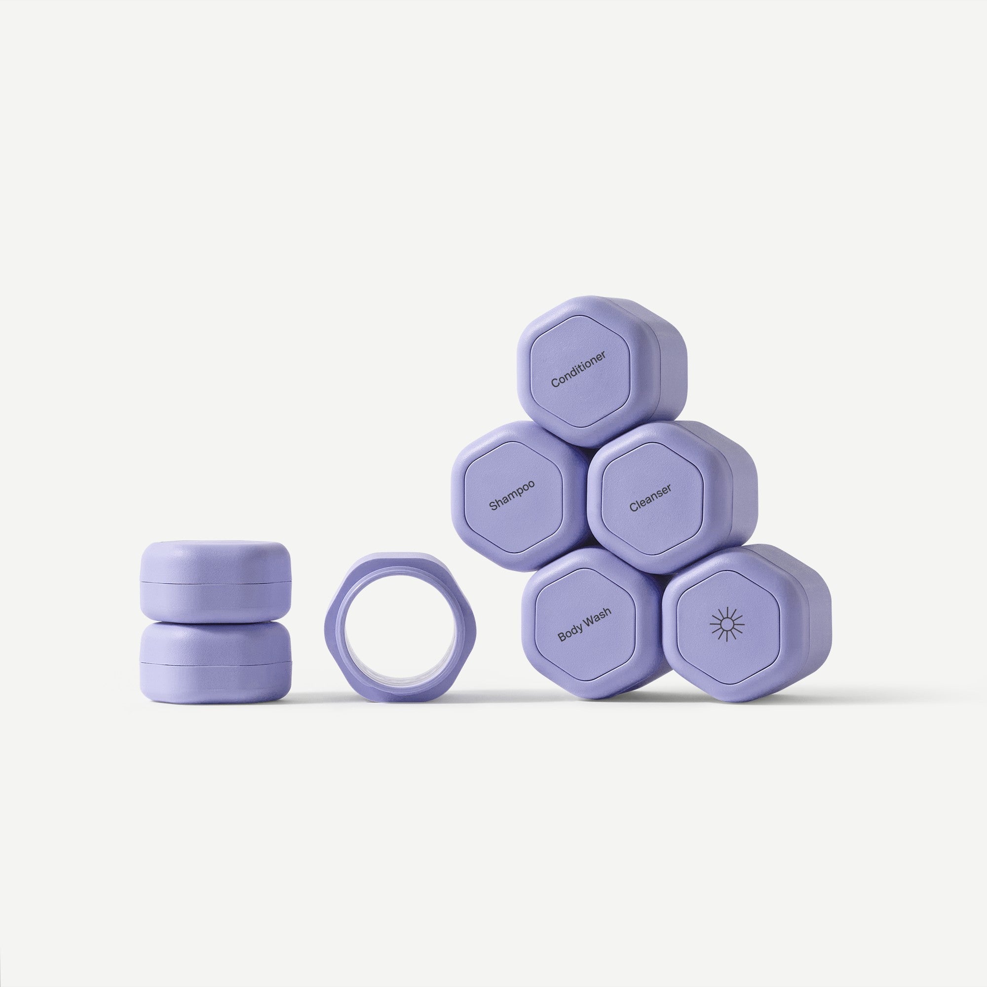 Set of purple hexagonal containers with different labels on a white background
