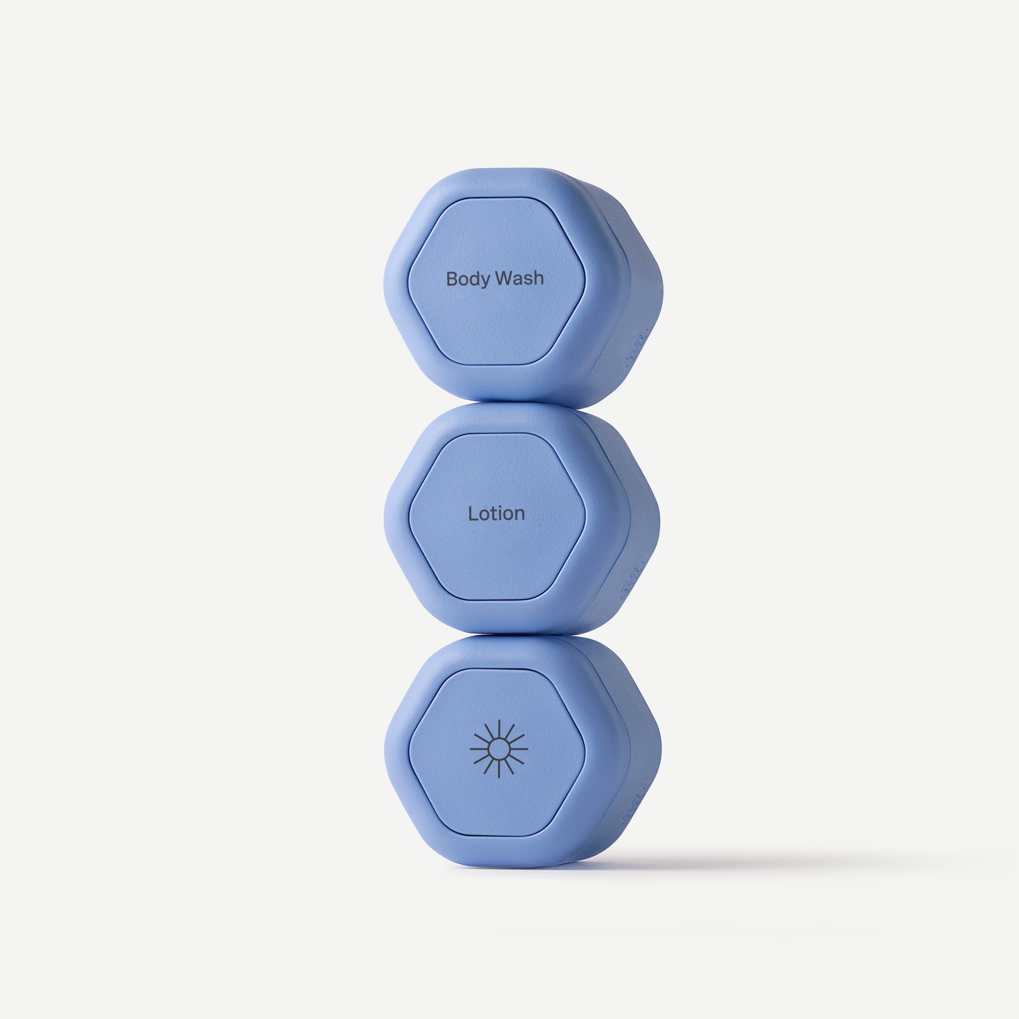 Three blue hexagonal weights stacked on a white background