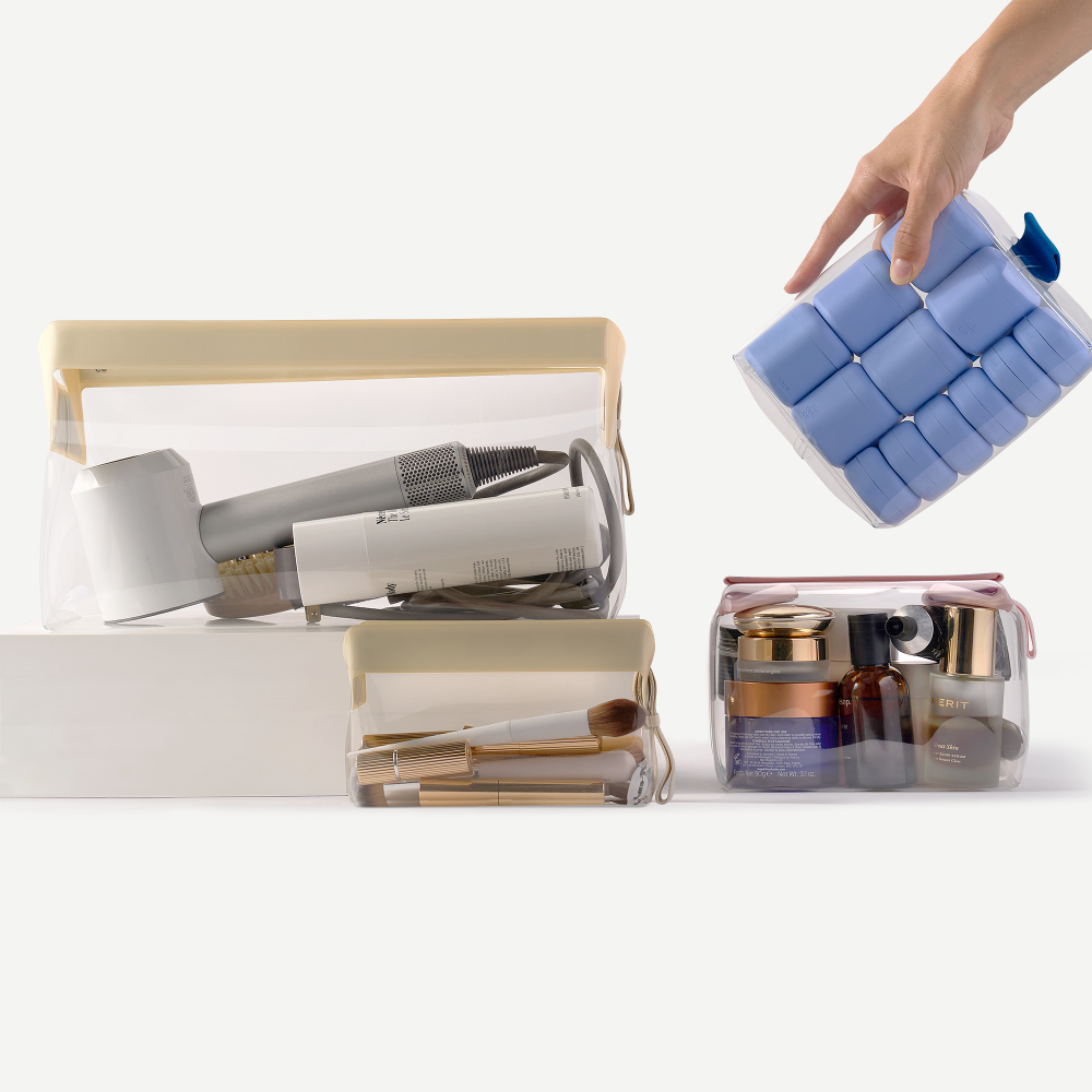 Clear travel bags with cosmetic items on a white background