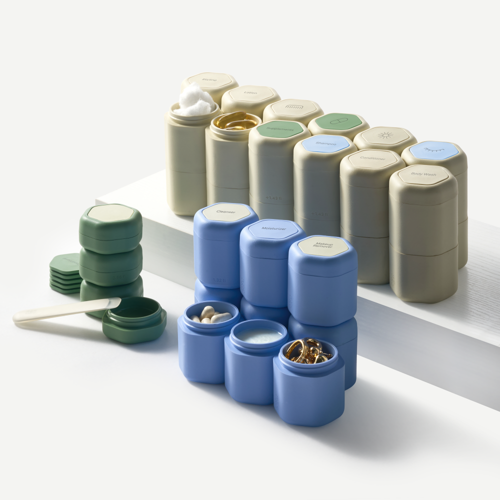 Set of small containers in various colors on a white surface