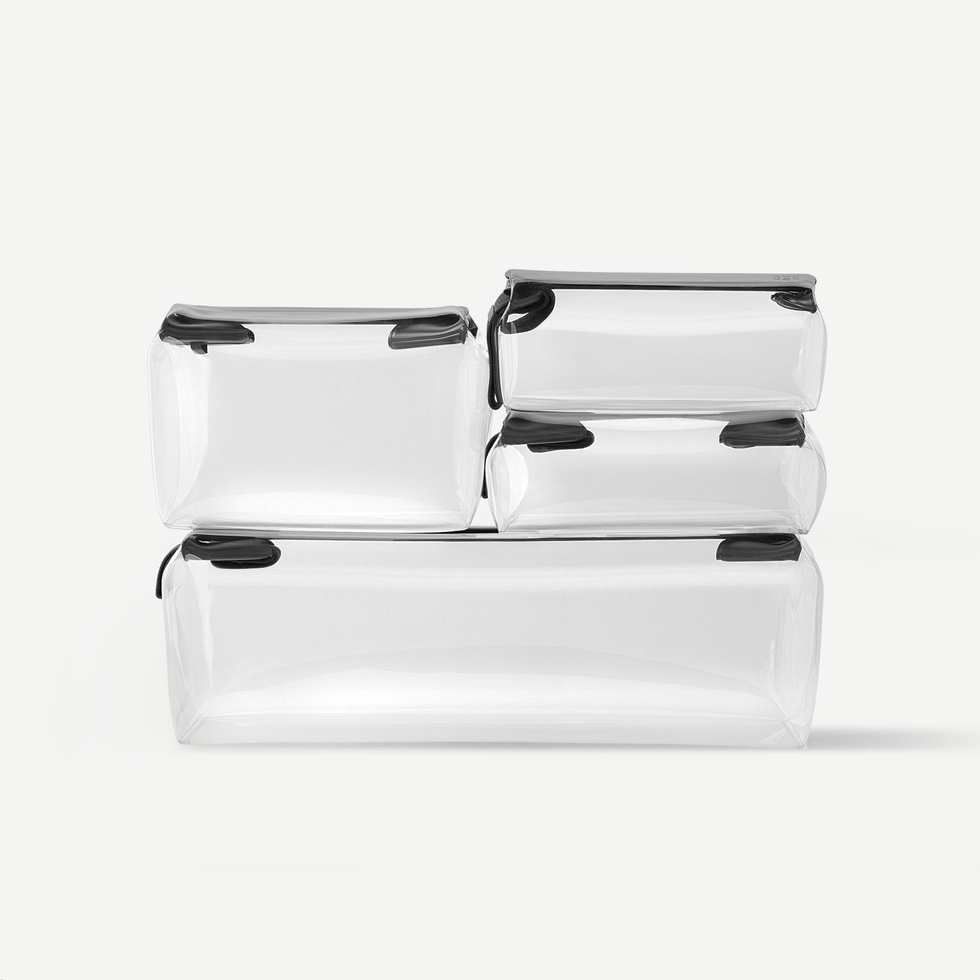 Set of clear plastic bags with black zippers on a white background