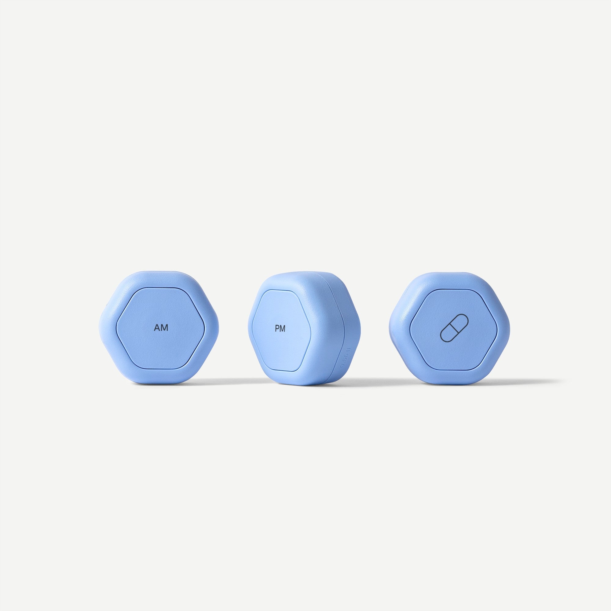 Three blue hexagonal devices labeled 'AM', 'PM', and with a pill icon on a white background