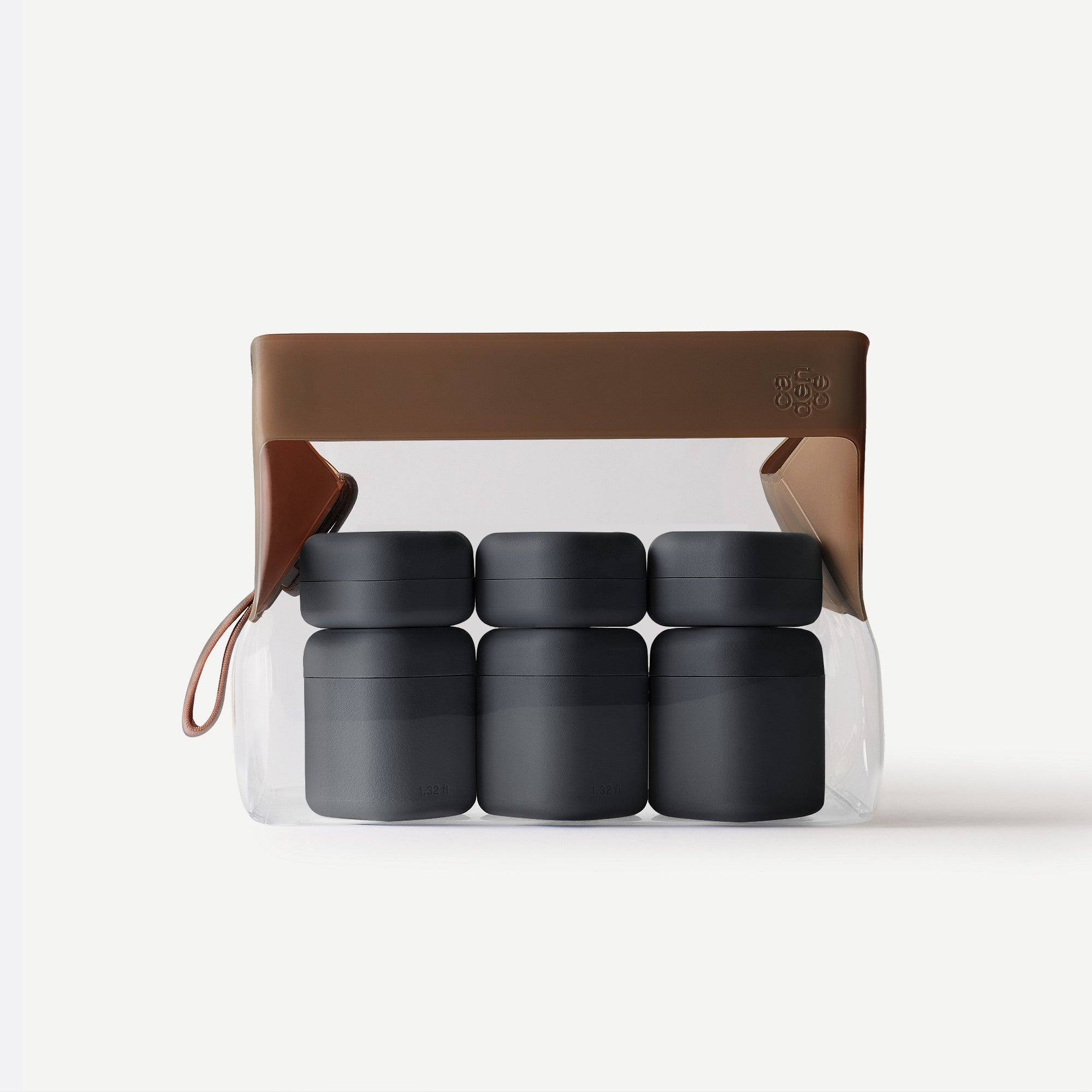 Set of four black containers in a transparent packaging with brown lid on a white background