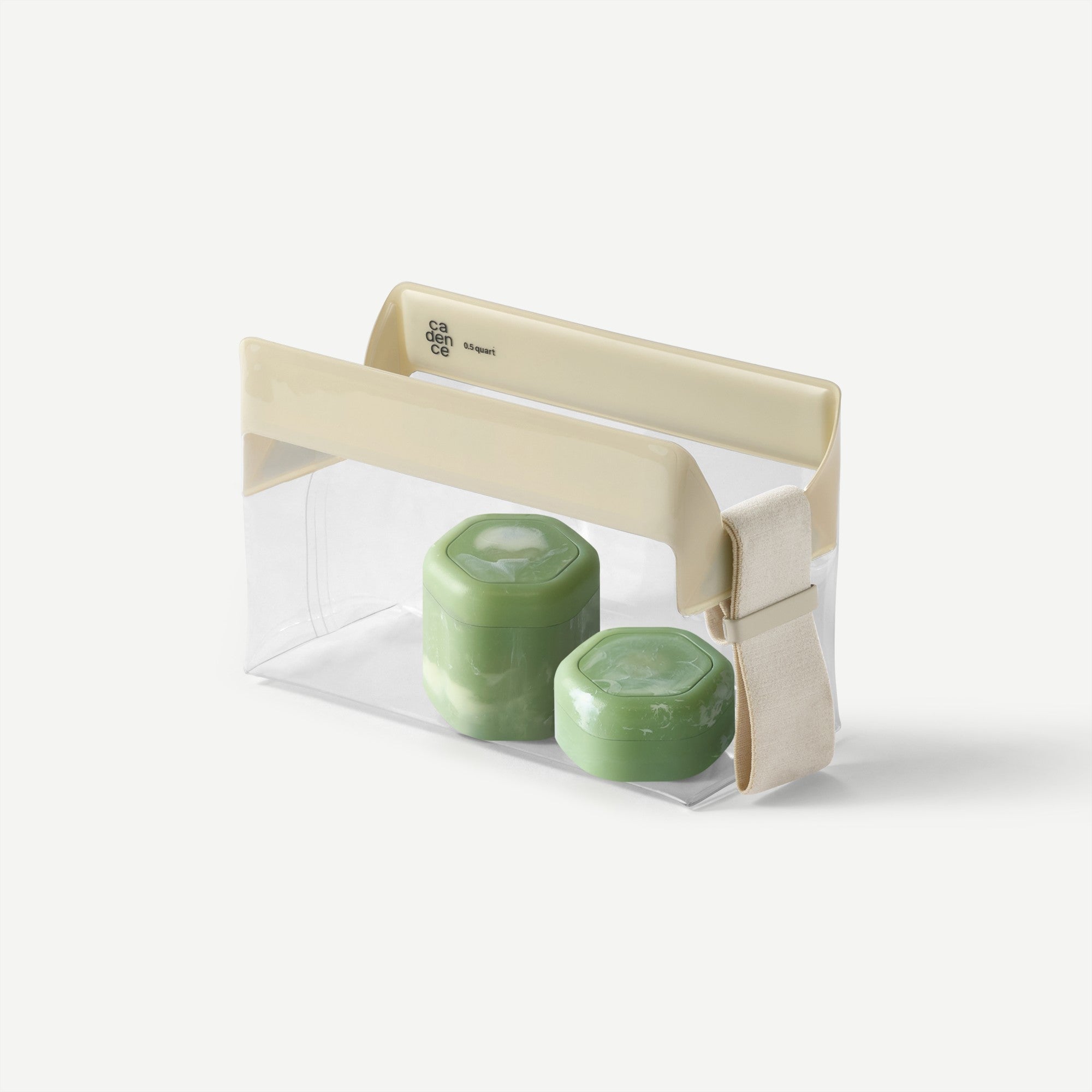 Two green candles in a clear container with a beige lid on a white background