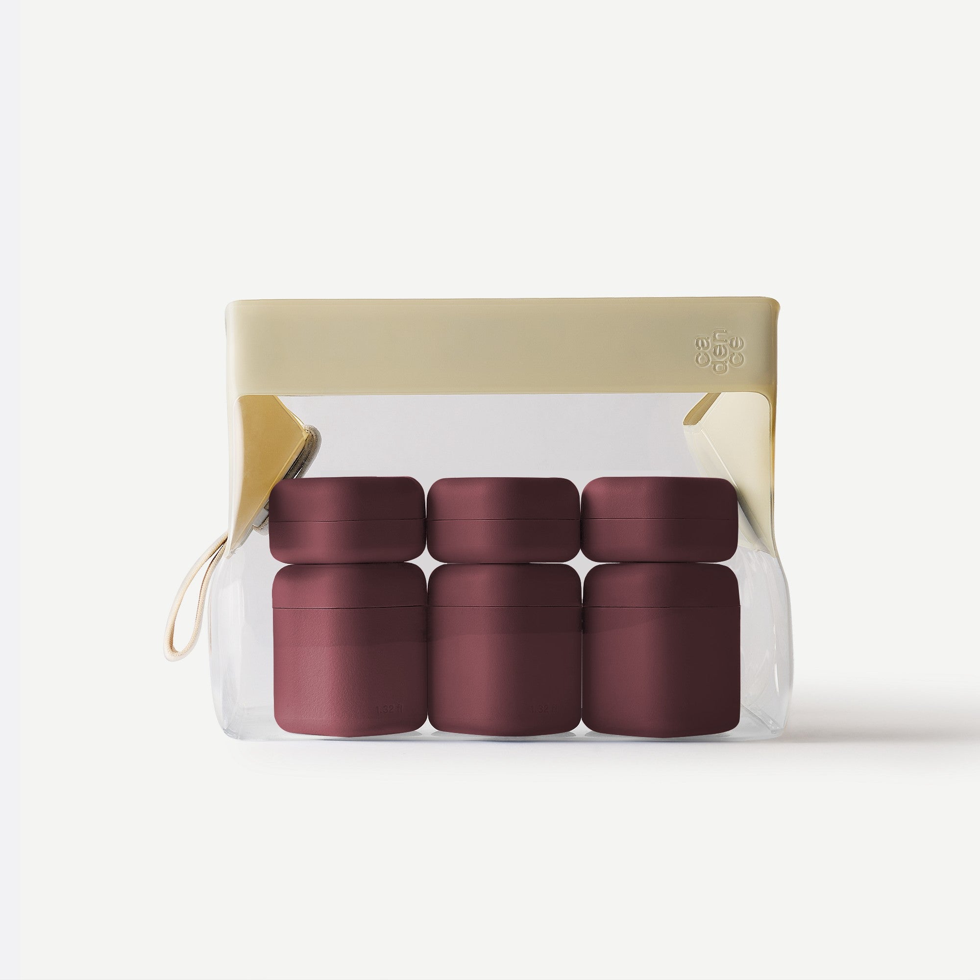 Set of four black containers in a clear plastic pack with beige lid on a white background