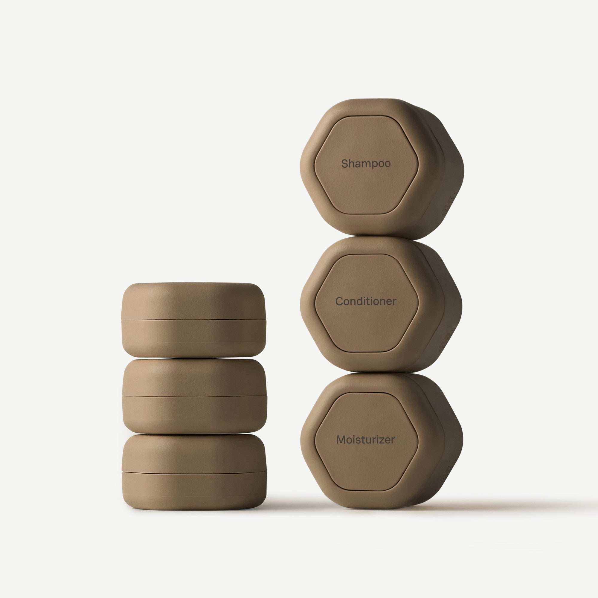 Set of hexagonal containers labeled 'Shampoo', 'Conditioner', and 'Moisturizer' on a white background