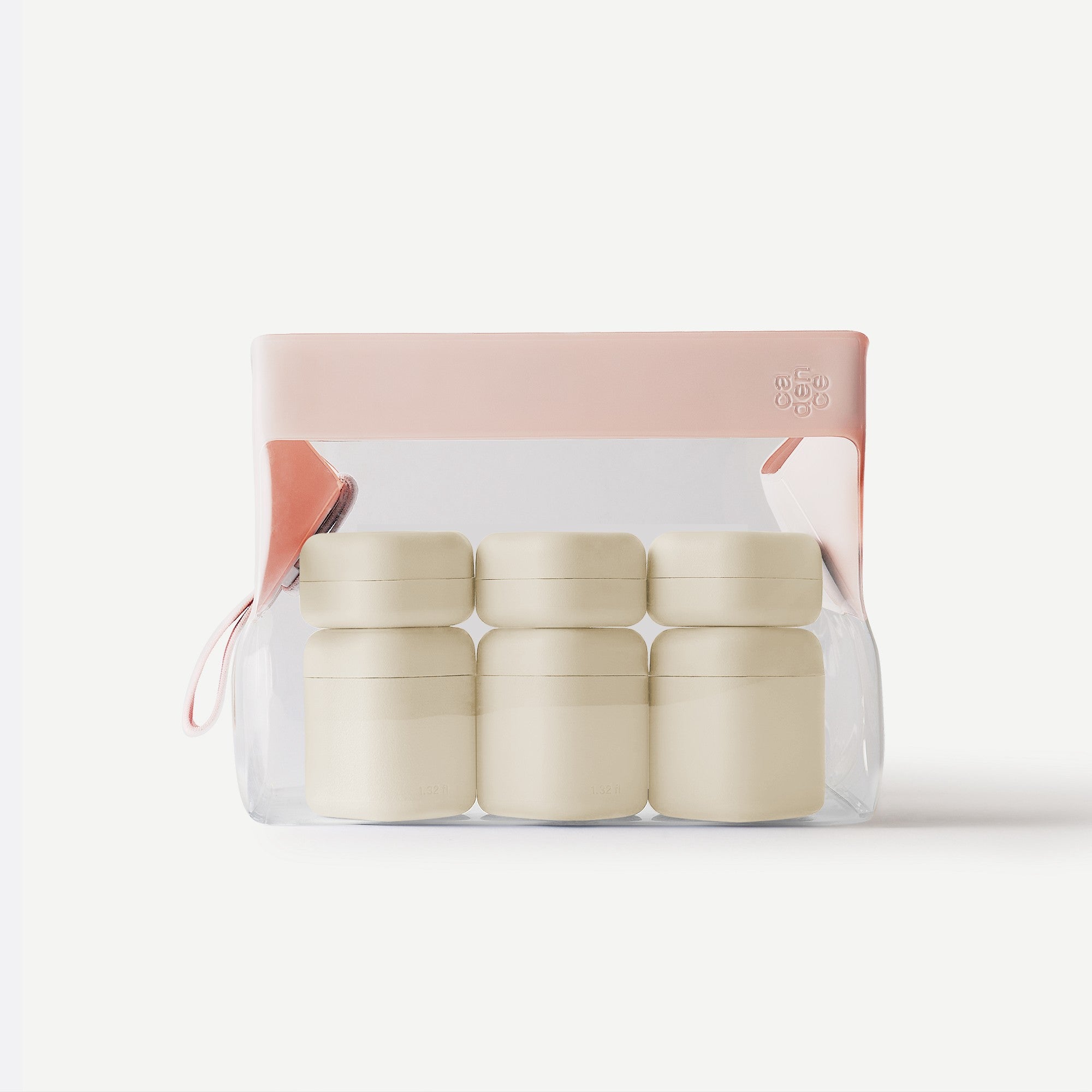 Set of four beige containers in a clear packaging with a pink lid on a white background