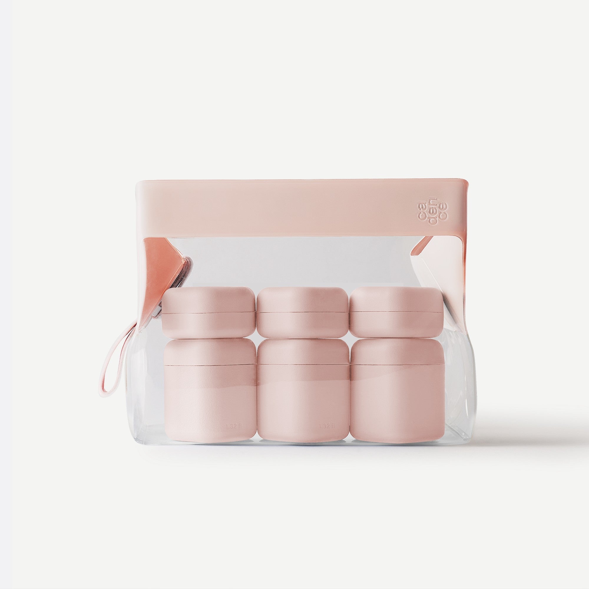 Set of pink containers in clear packaging on a white background
