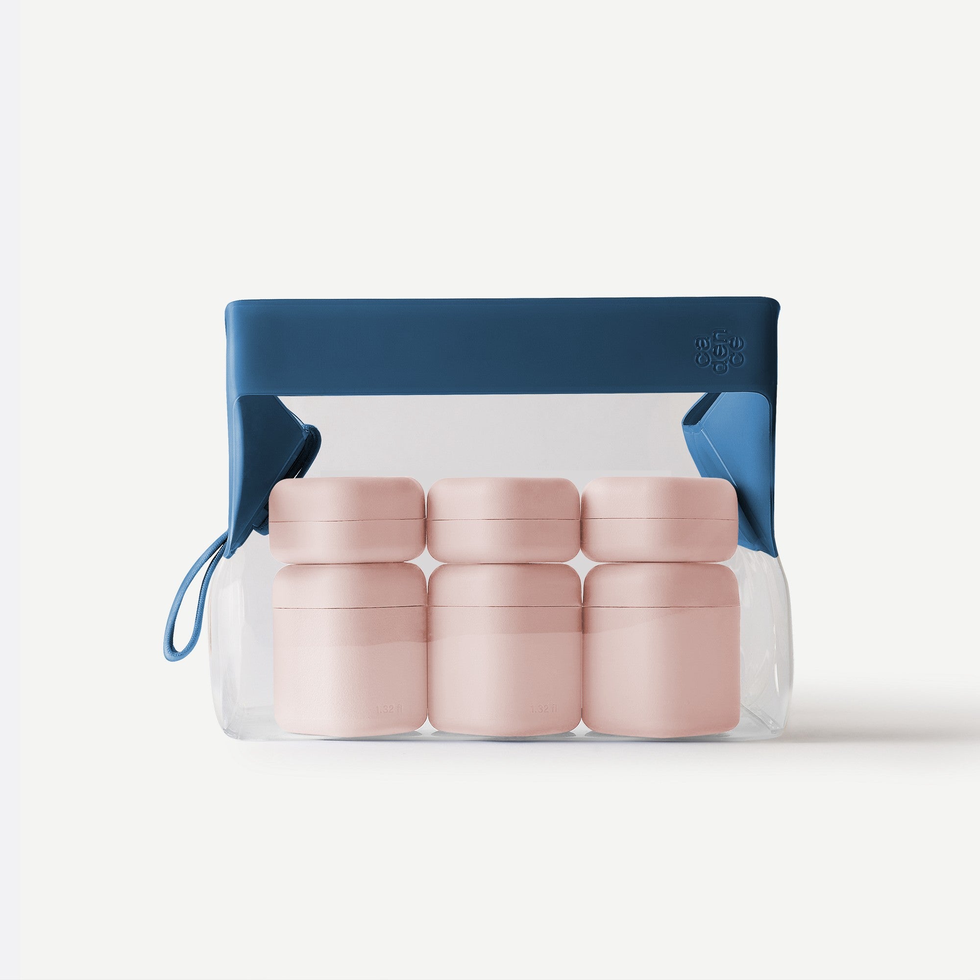 Set of pink containers in a clear plastic bag with a blue handle on a white background