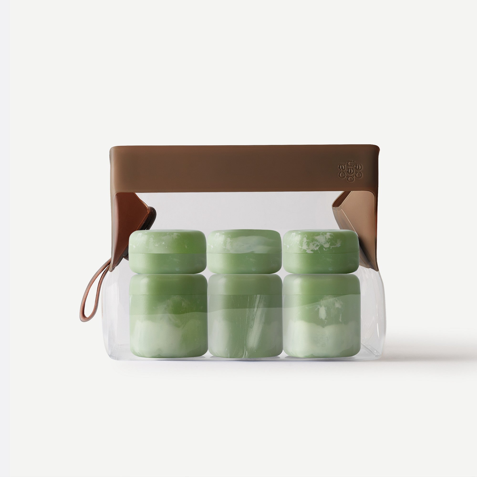 Set of green containers in a clear plastic pack with a brown lid on a white background
