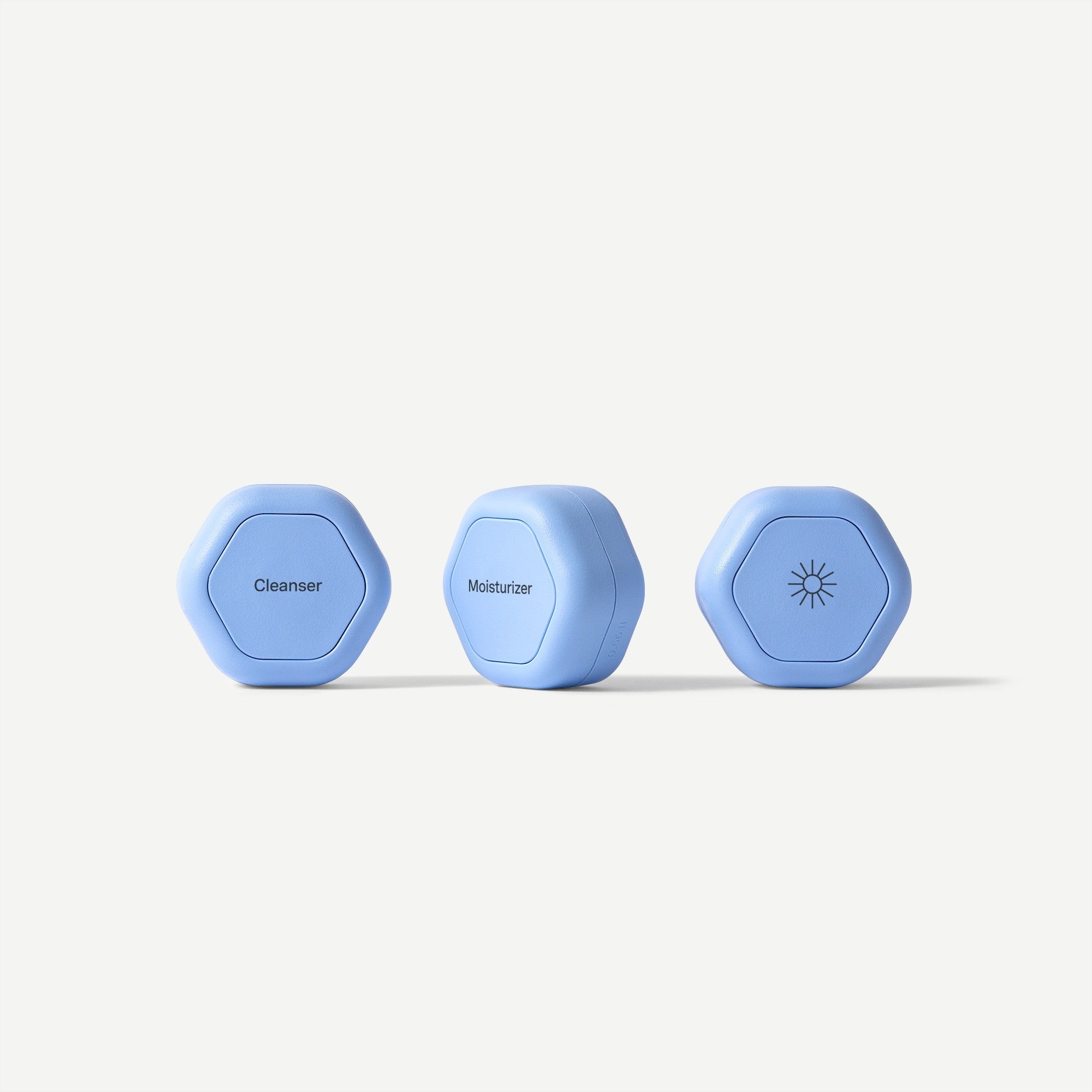 Three blue hexagonal skincare devices labeled 'Cleanser', 'Moisturizer', and 'Sun' on a white background.