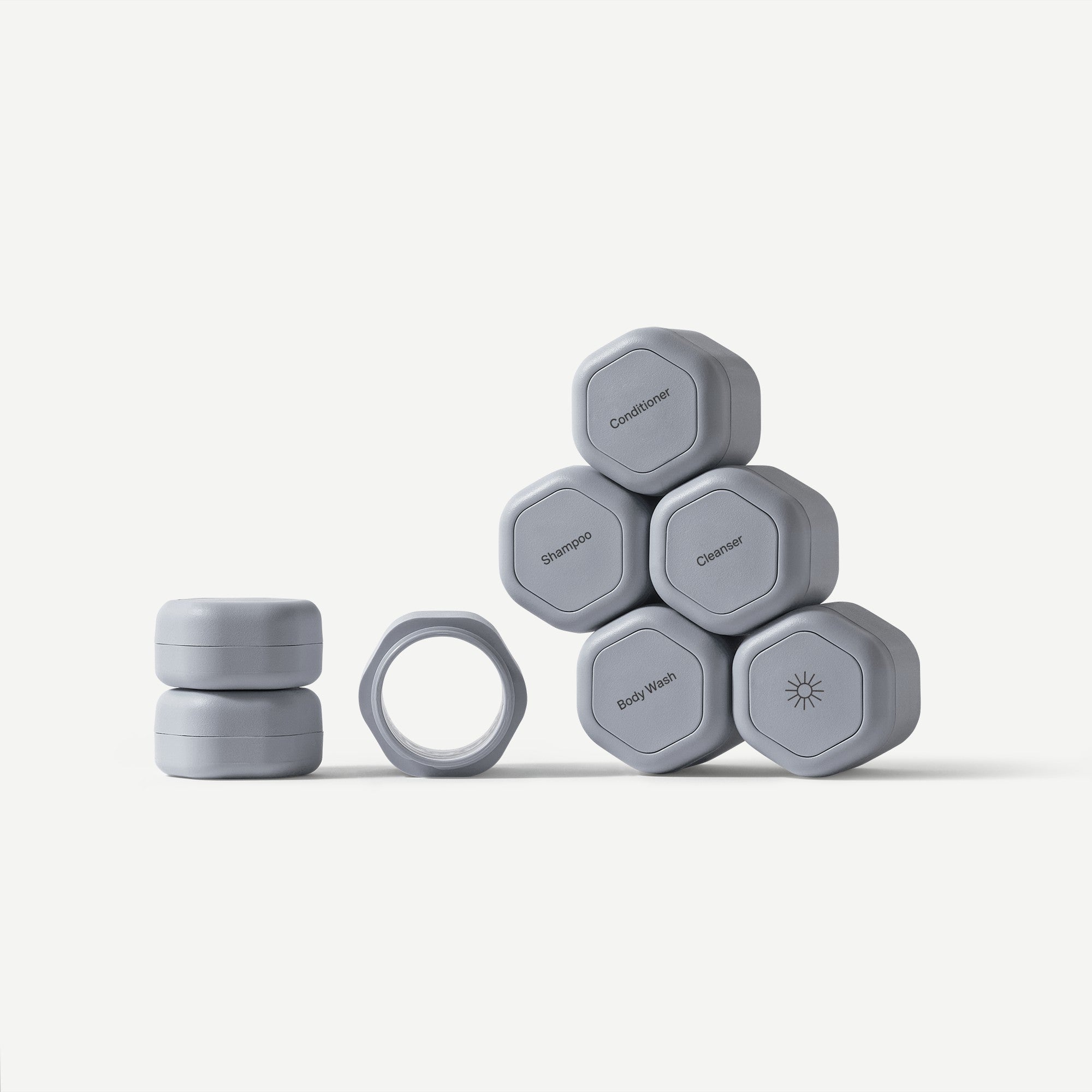 Set of gray hexagonal containers with labels on a white background