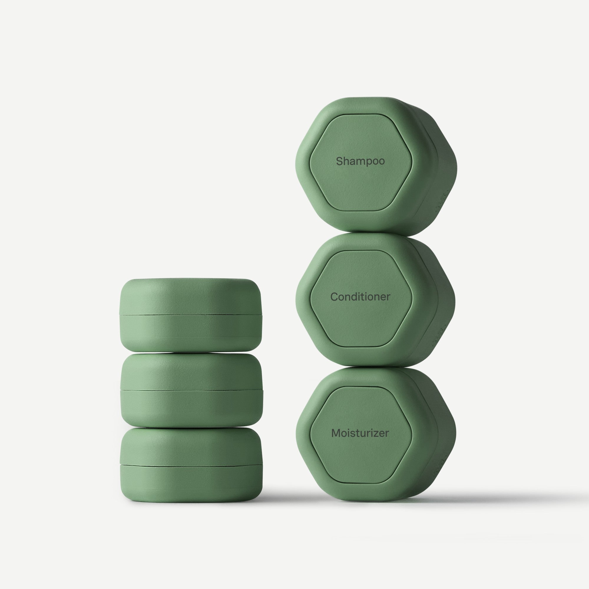 Set of green hexagonal containers labeled 'Shampoo', 'Conditioner', and 'Moisturizer' on a white background.