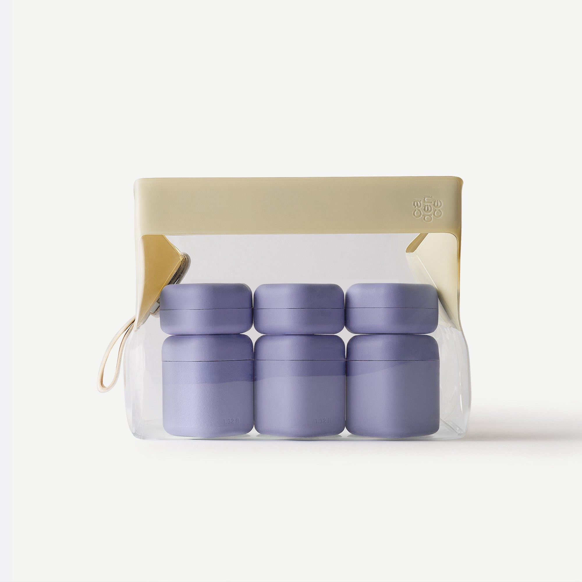 Set of purple containers in a clear plastic pack with beige lid on a white background