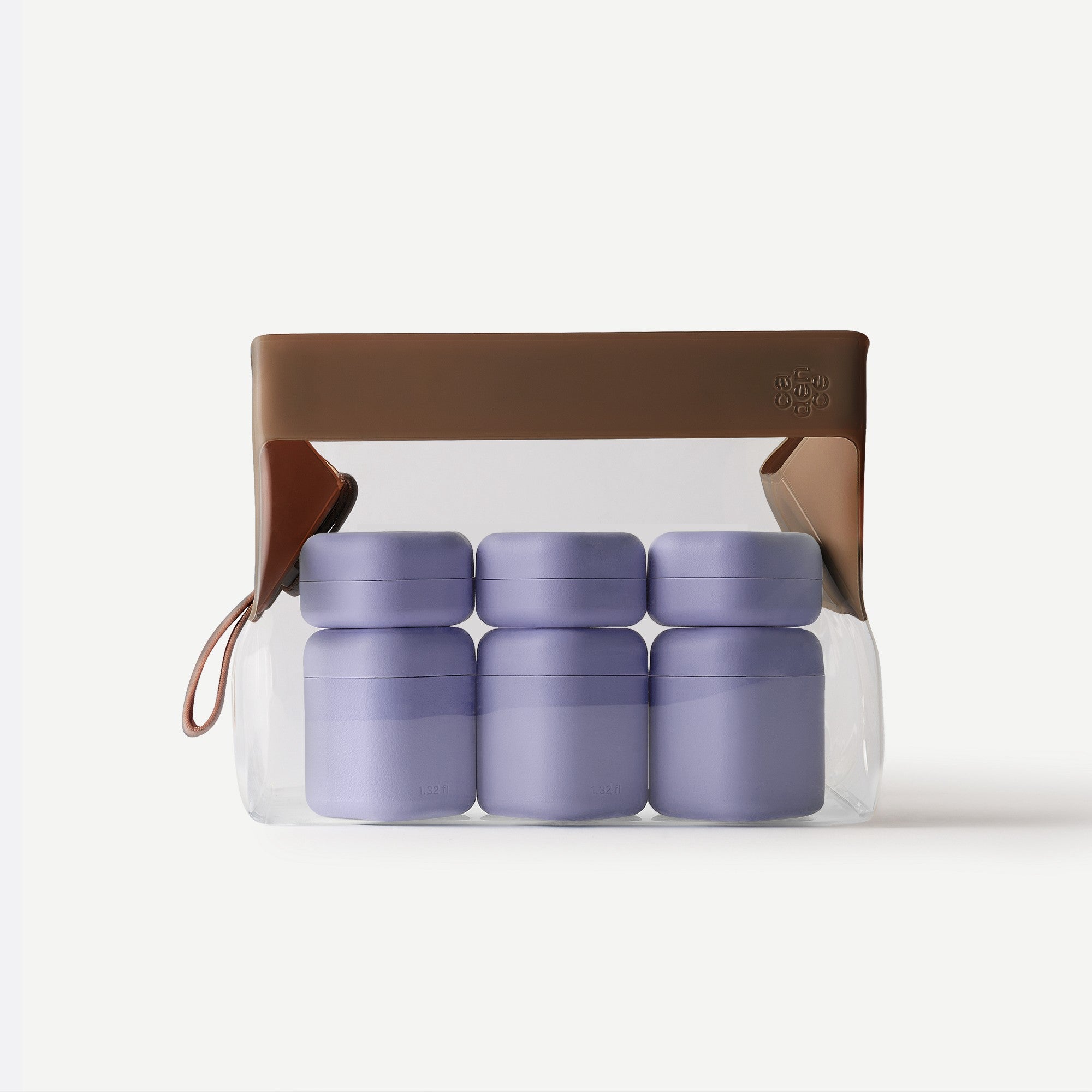 Set of purple containers in a clear plastic bag with a brown handle on a white background