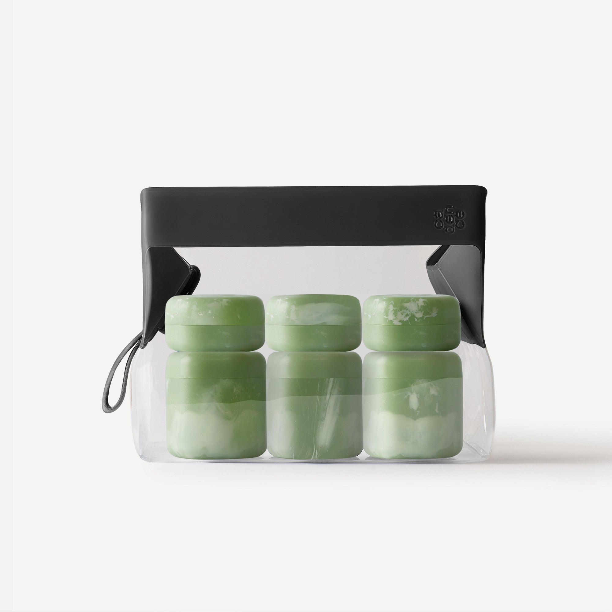 Set of green containers in a clear plastic bag with a black lid on a white background