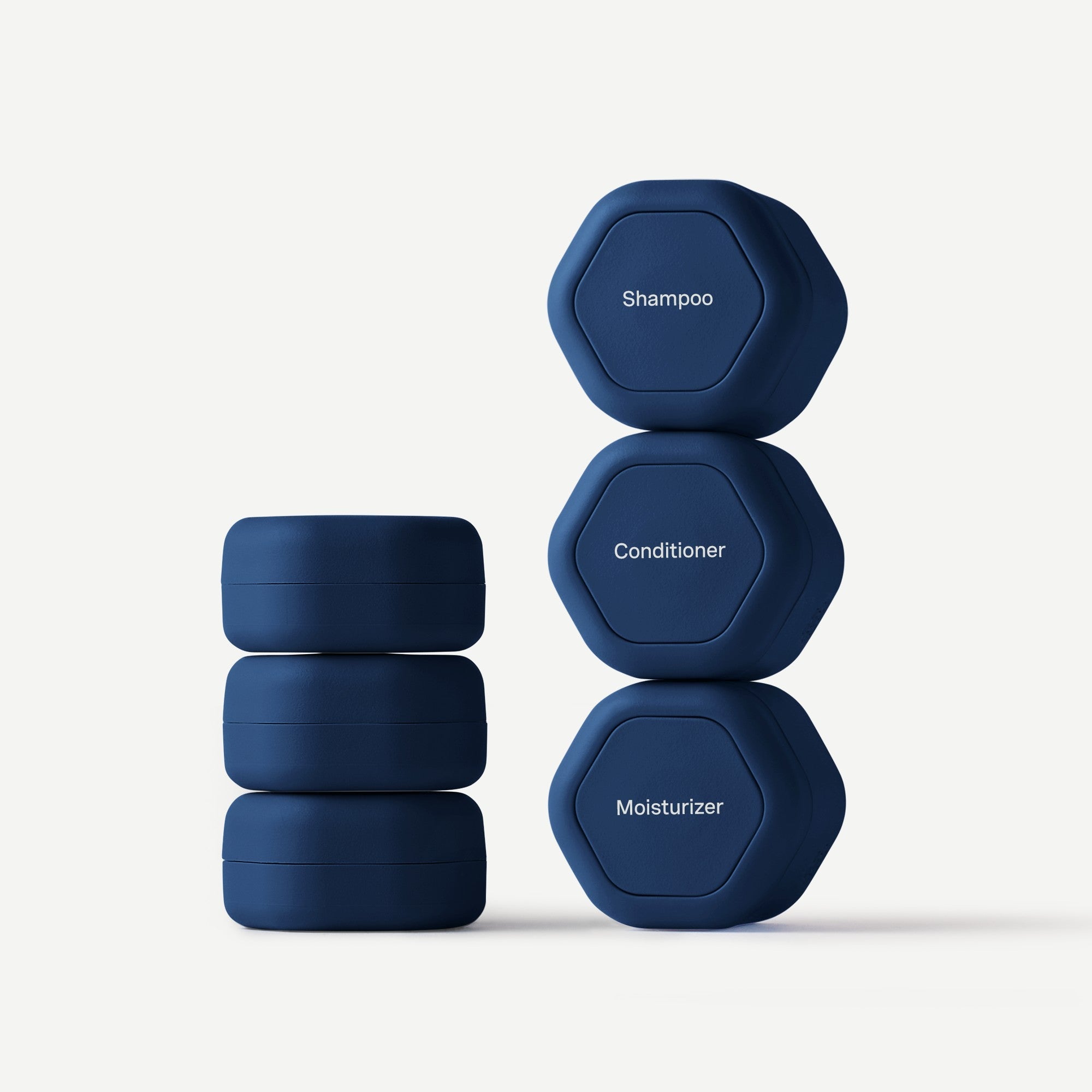 Set of blue hexagonal containers labeled 'Shampoo', 'Conditioner', and 'Moisturizer' on a white background