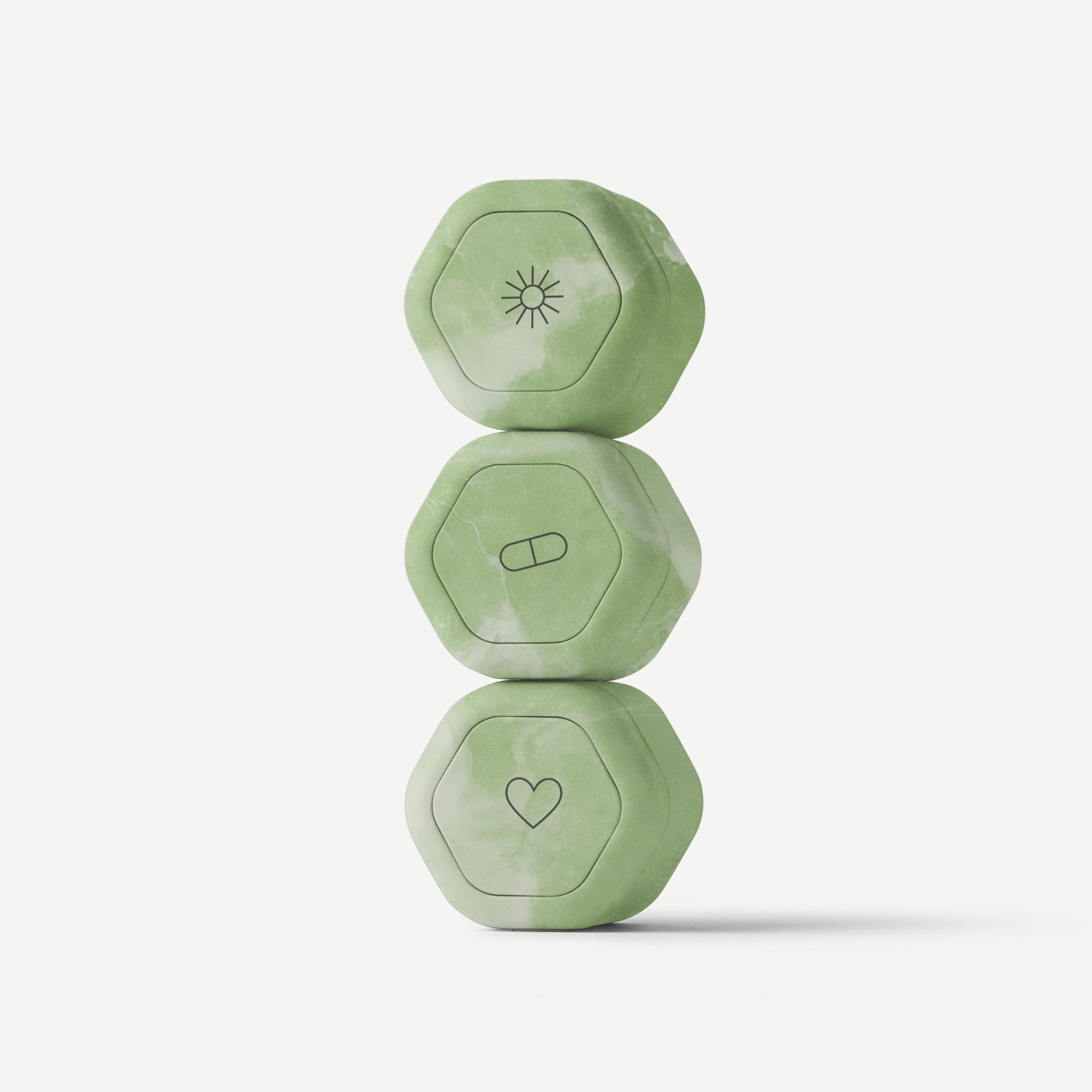 Three green hexagonal weights stacked on a white background