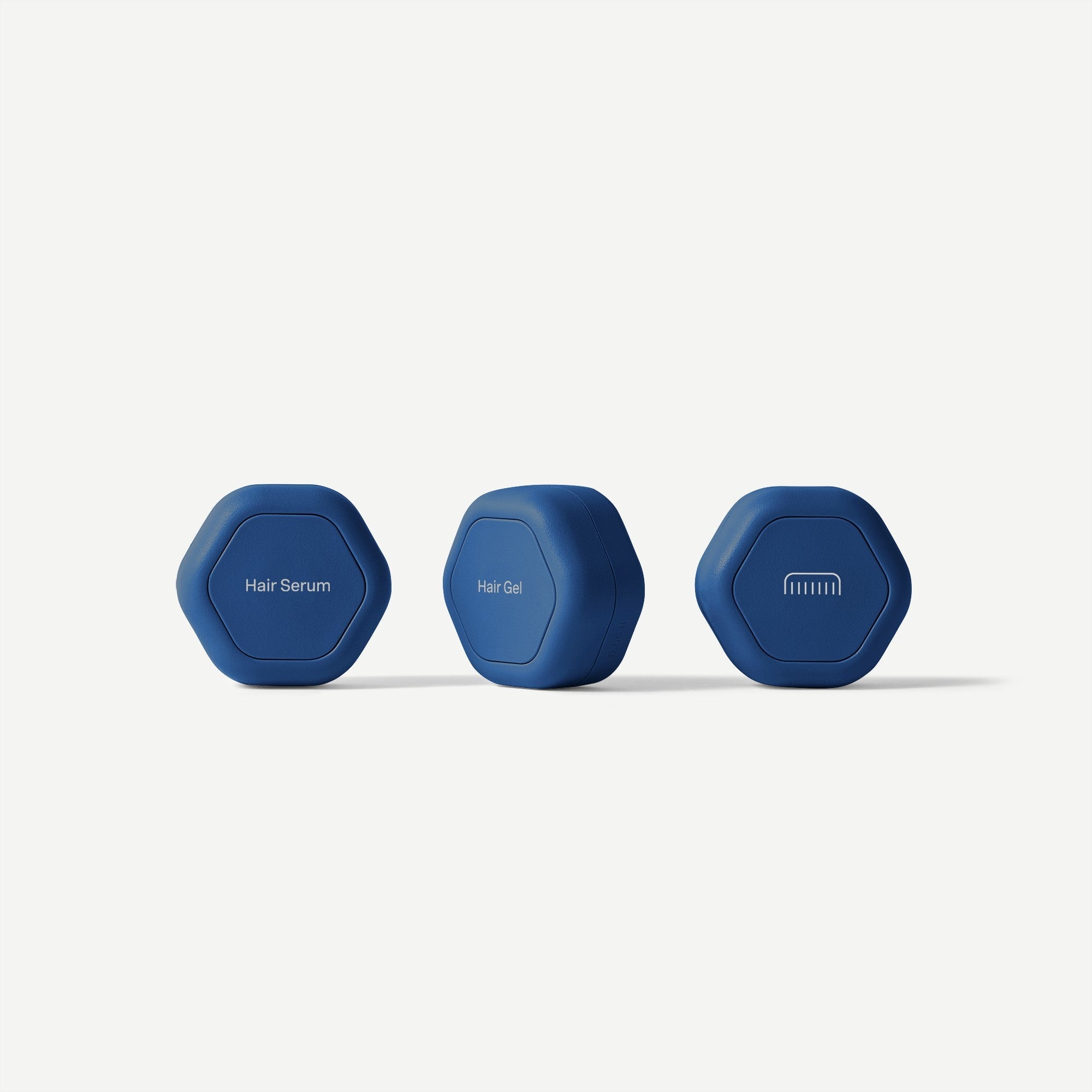 Three blue hexagonal containers labeled 'Hair Serum', 'Hair Gel', and 'Shampoo' on a white background.