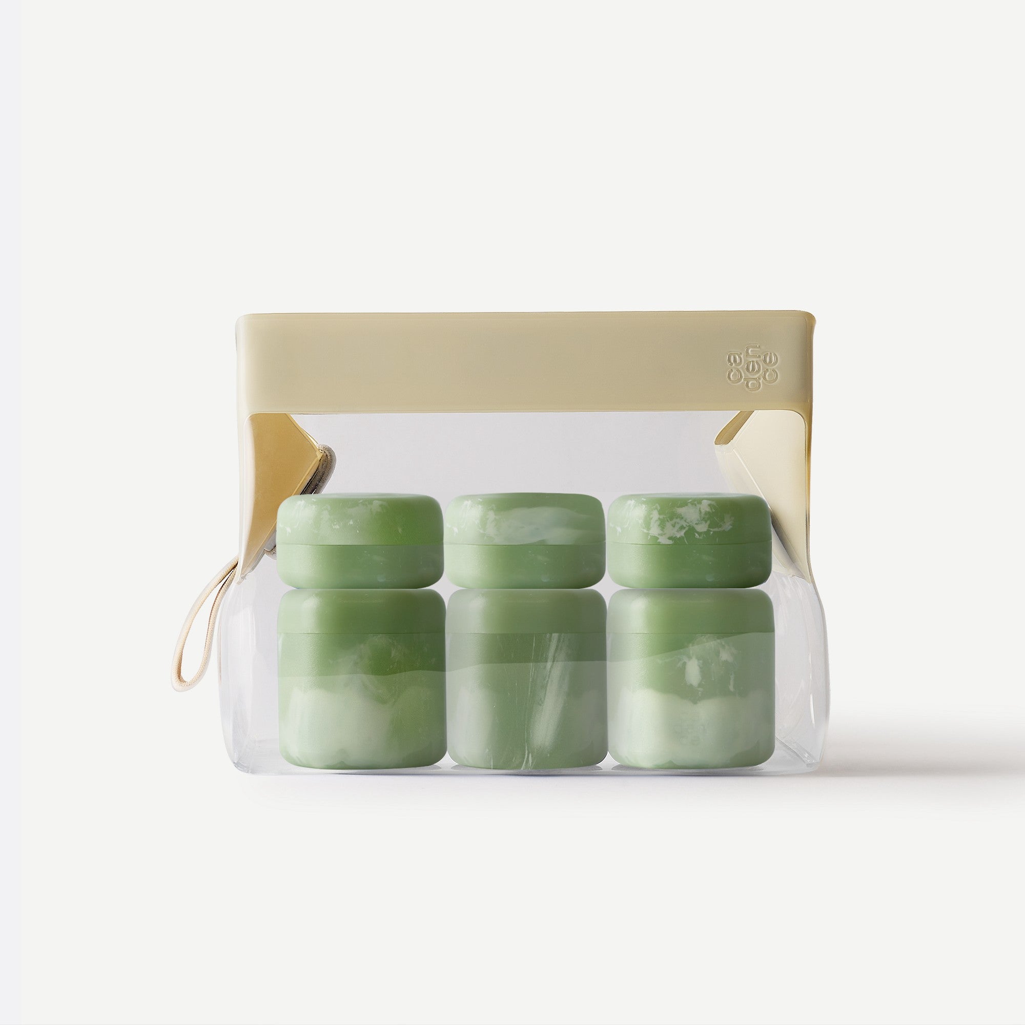 Set of green containers in a clear packaging with beige lid on a white background