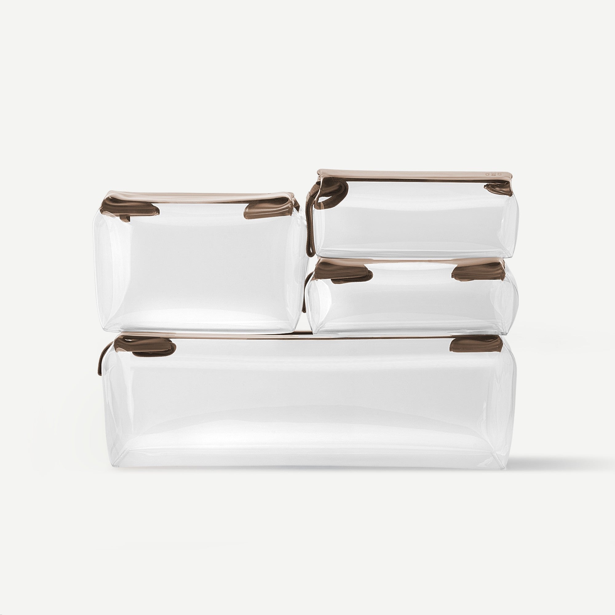 Set of white bags with brown zippers on a light gray background