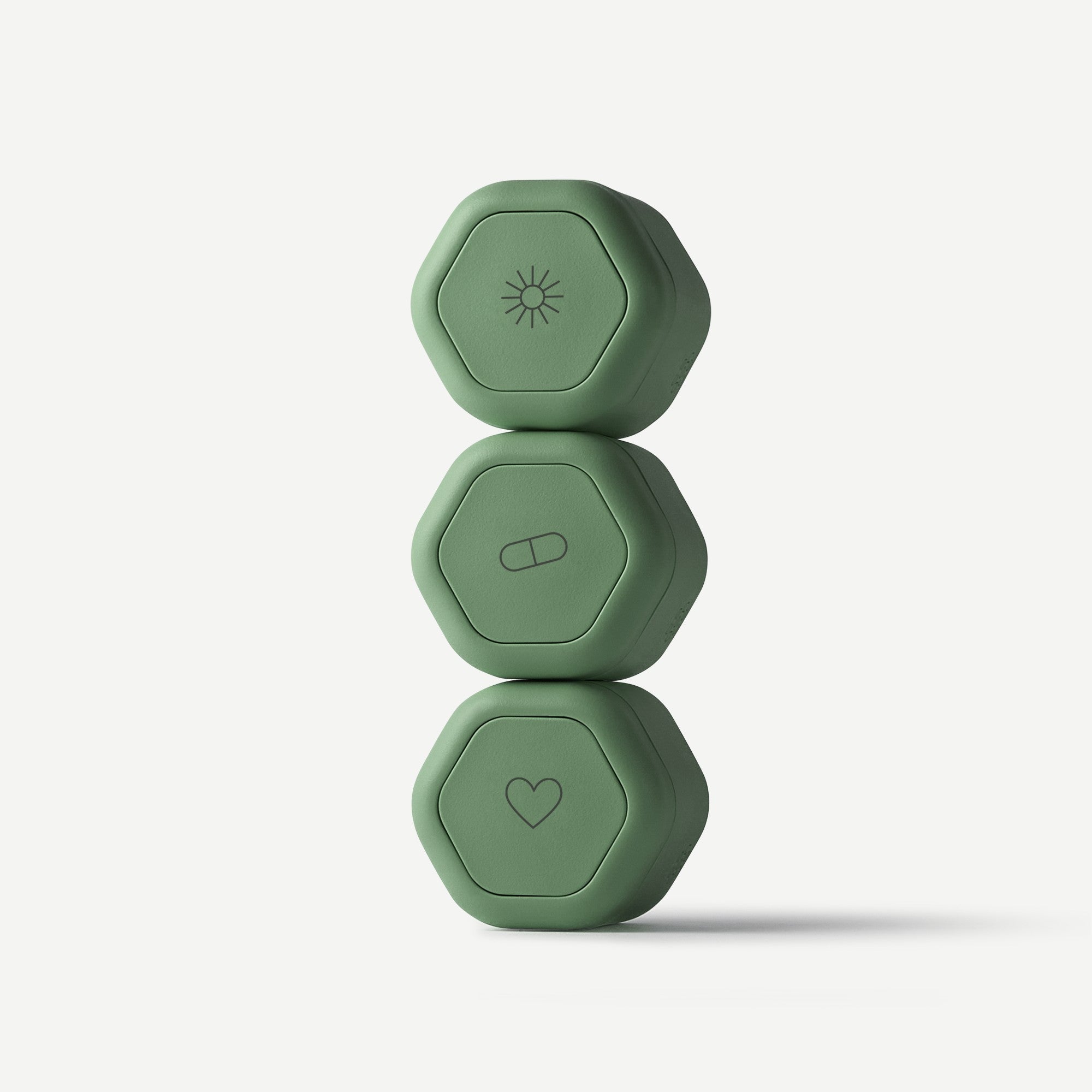 Three green hexagonal fitness weights stacked on a white background