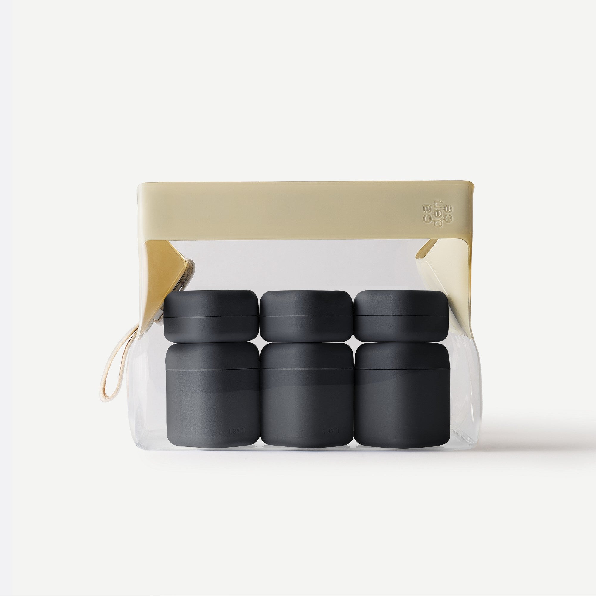 Set of four black containers in a clear plastic pack with beige lid on a white background