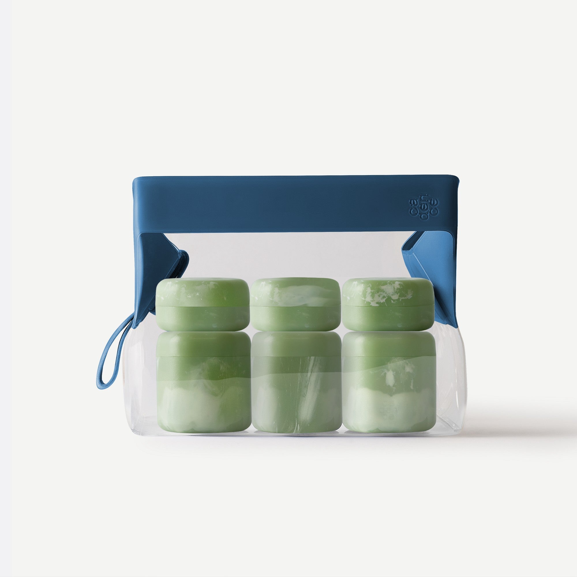 Set of green containers in a clear plastic bag with blue handle on a white background