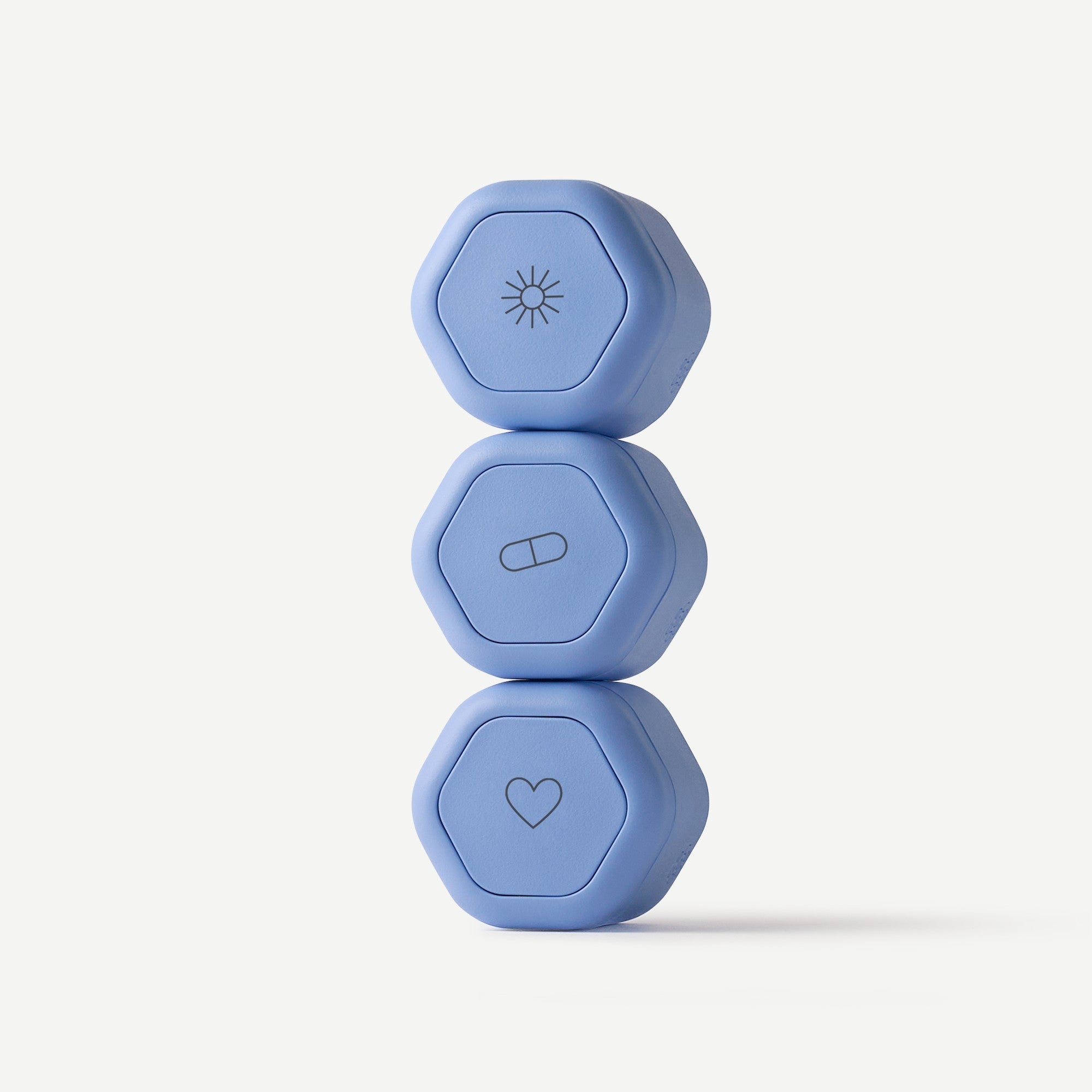 Three blue hexagonal weights stacked on a white background
