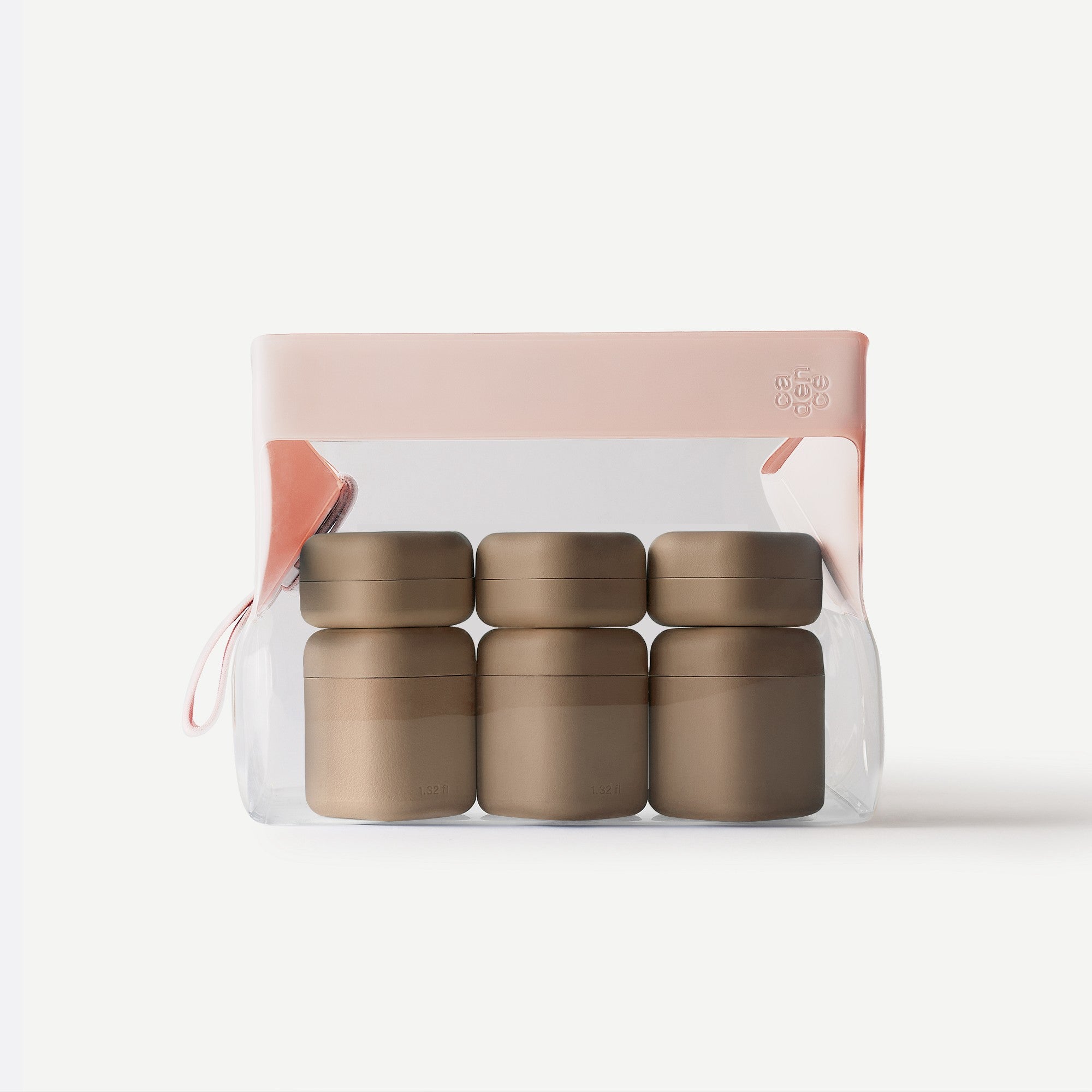 Set of four gold containers in a clear package with a pink lid on a white background