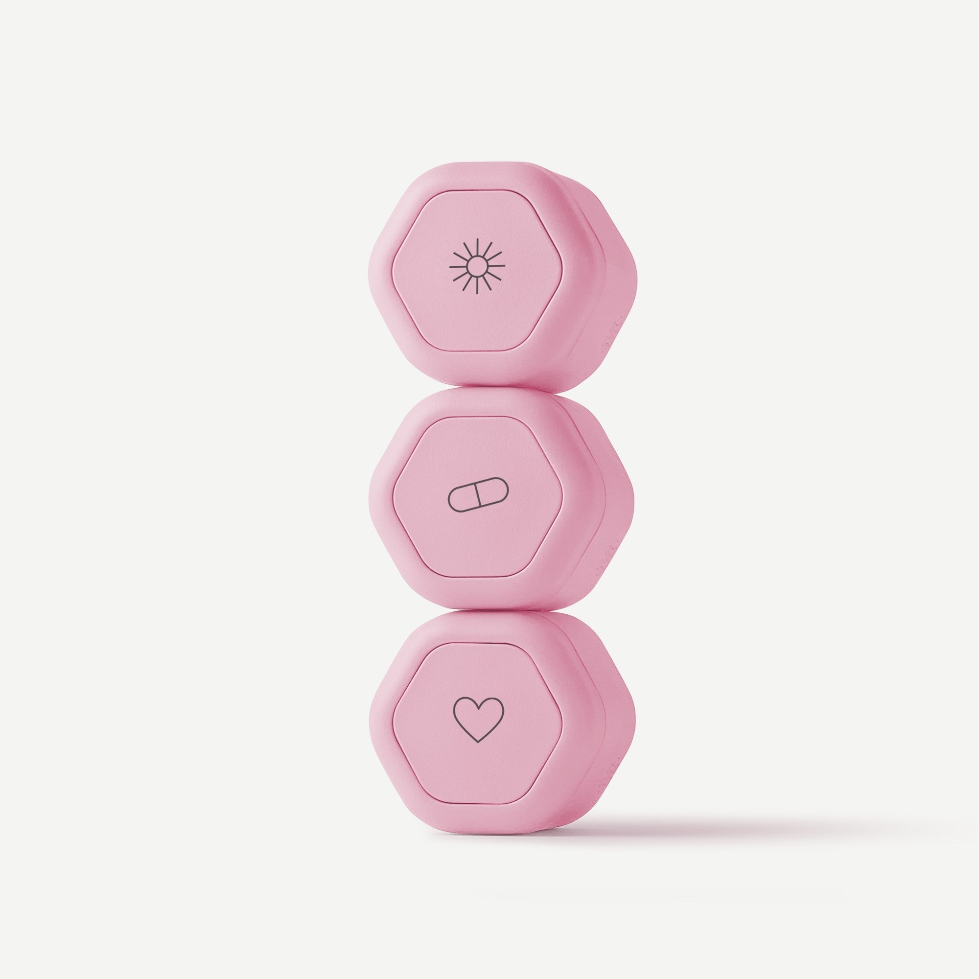 Set of three pink dumbbells with different symbols on a light pink background