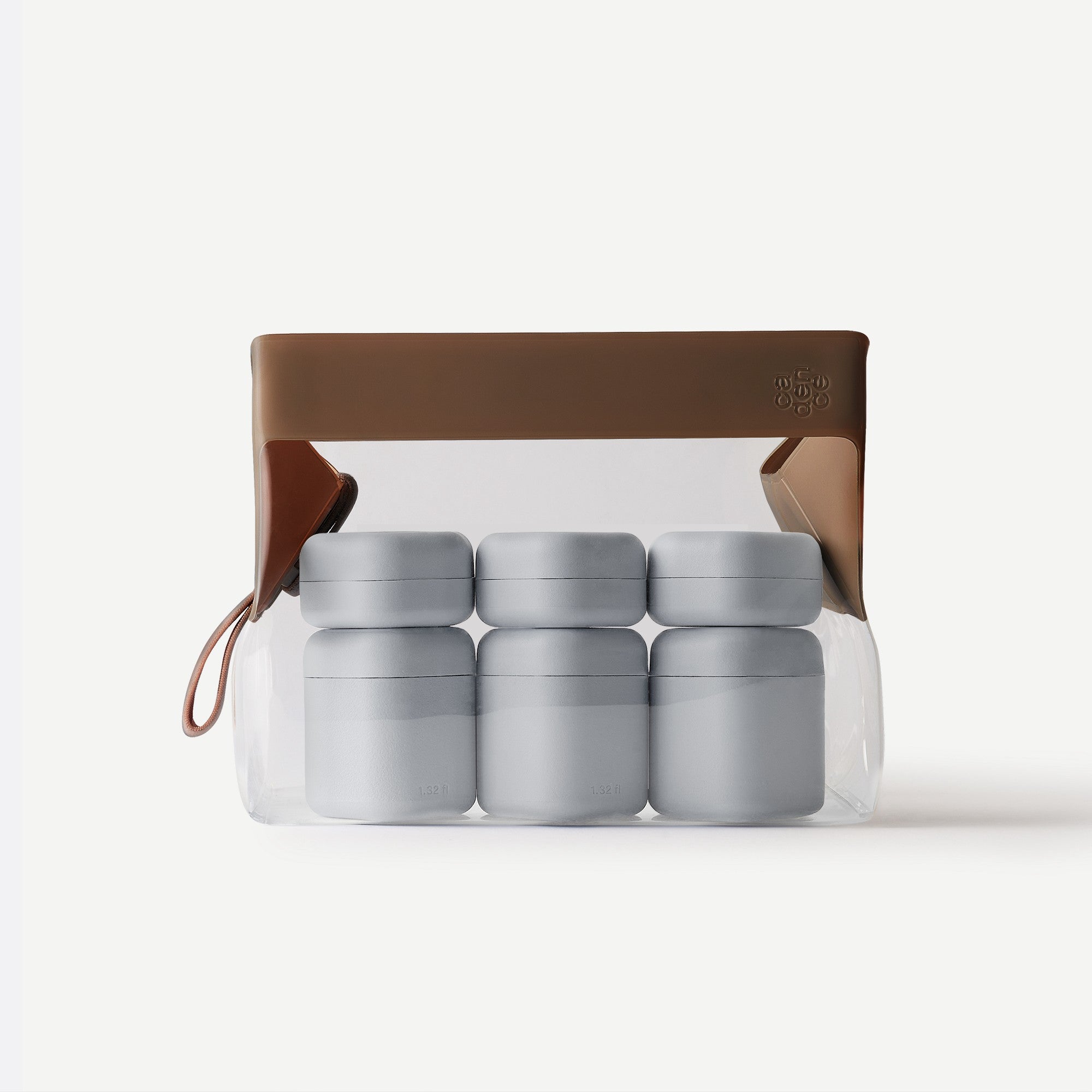 Set of gray containers in a clear plastic pack with a brown leather strap on a white background
