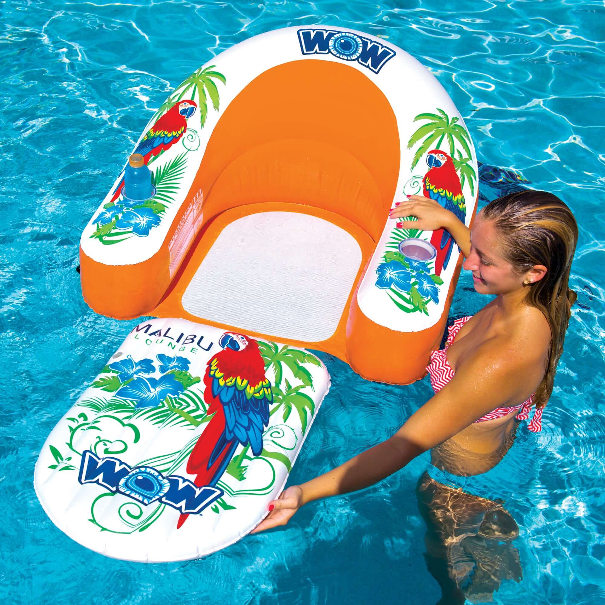 Woman holding an inflatable pool float with parrot design in a pool