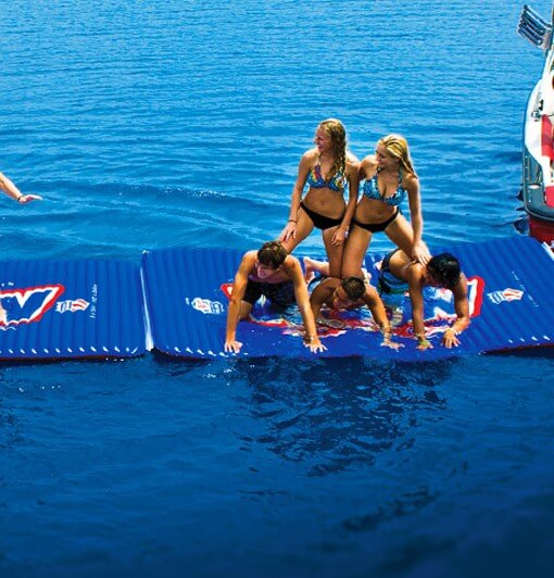 People on a floating platform in the water with a blue background