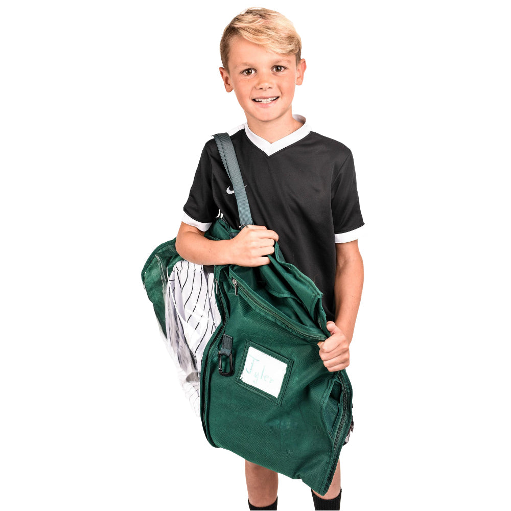 A young boy wearing a black and white soccer jersey carries a large green duffel bag with a white Nike swoosh on the shoulder, set against a plain white background.