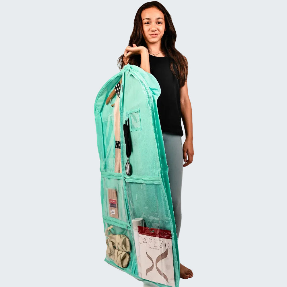 A woman holds up a mint green hanging organizer bag with multiple pockets and clear sections, shown against a plain white background.