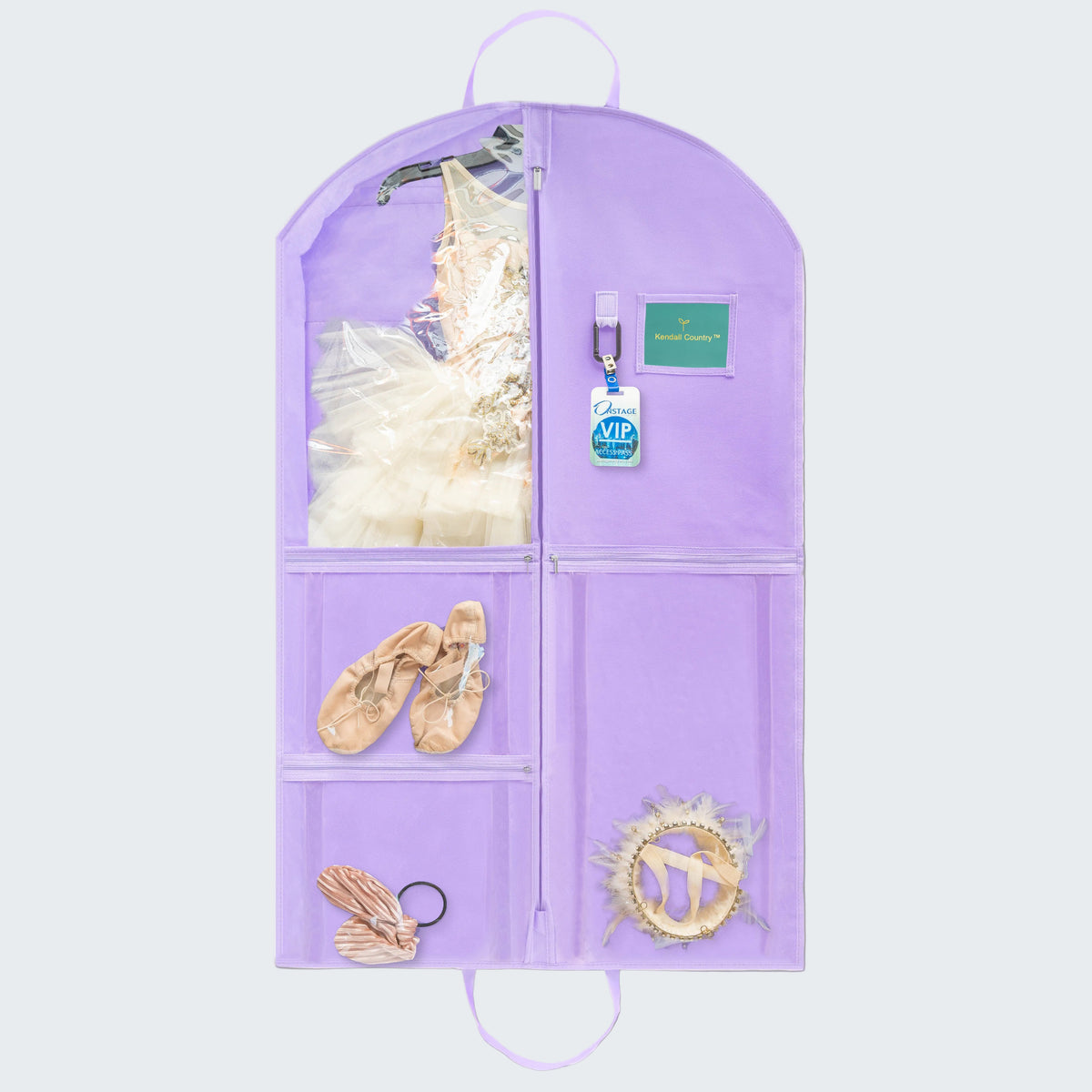 A lavender purple hanging garment organizer with multiple compartments, shown against a white background. The organizer is styled with ballet attire, including a tutu, pointe shoes, a wing, and a ribbon.