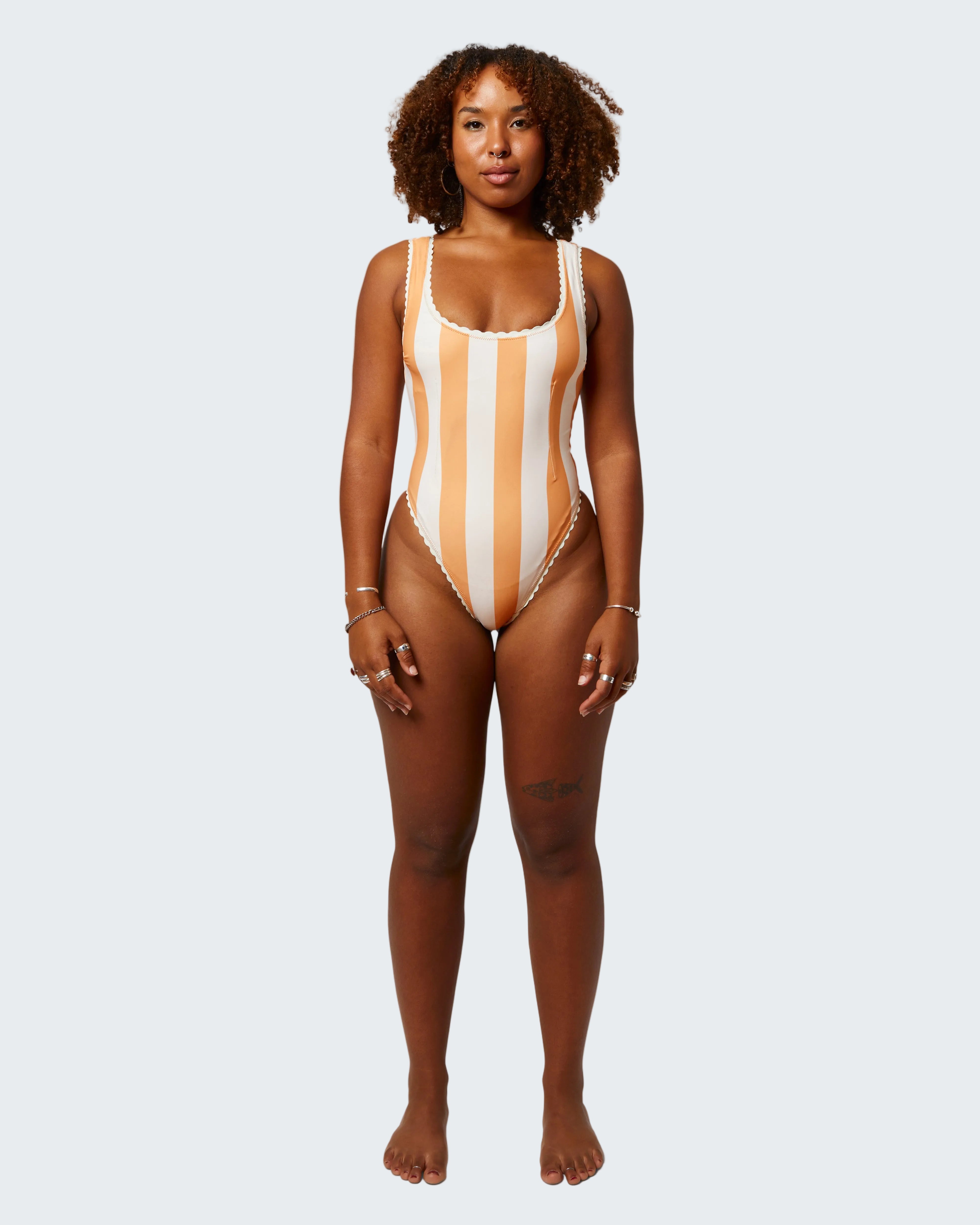Woman wearing a striped swimsuit on a white background