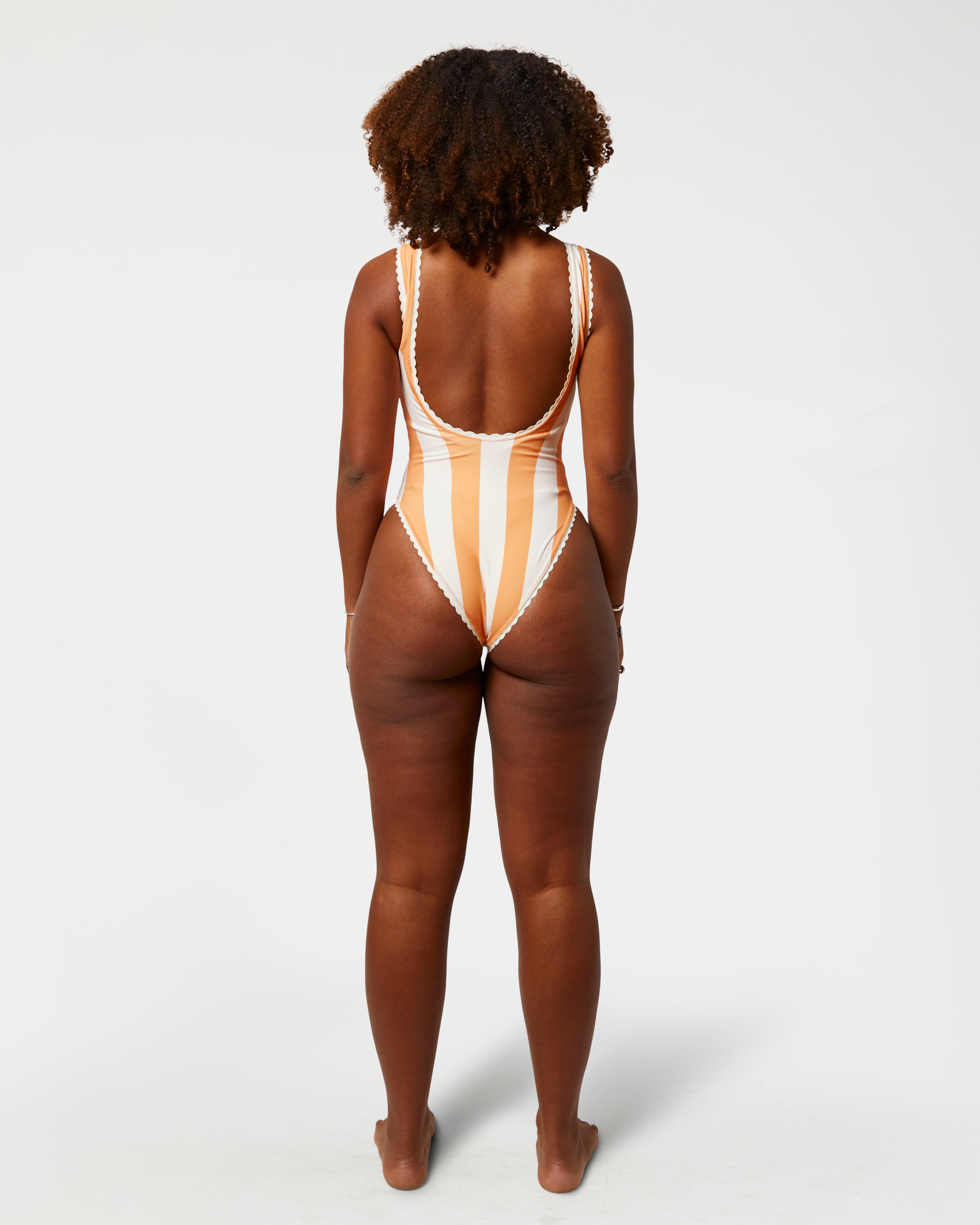 Person wearing a striped swimsuit on a white background