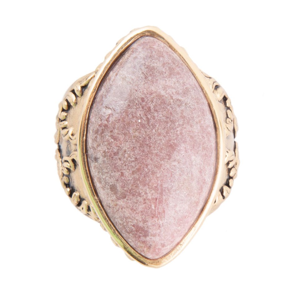 Ring with pink stone and gold band on a white background